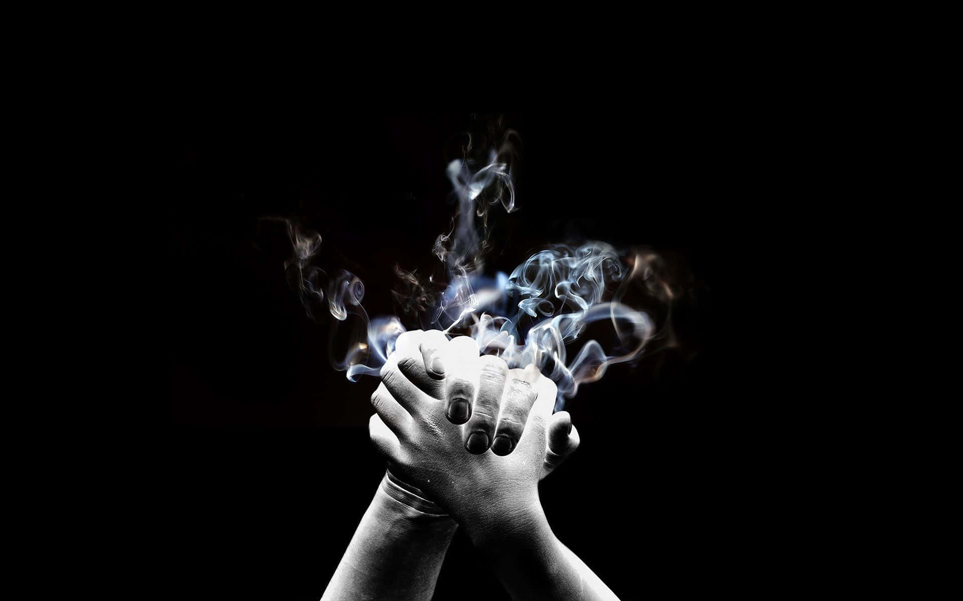 Two Joint Hands With Smoke Background