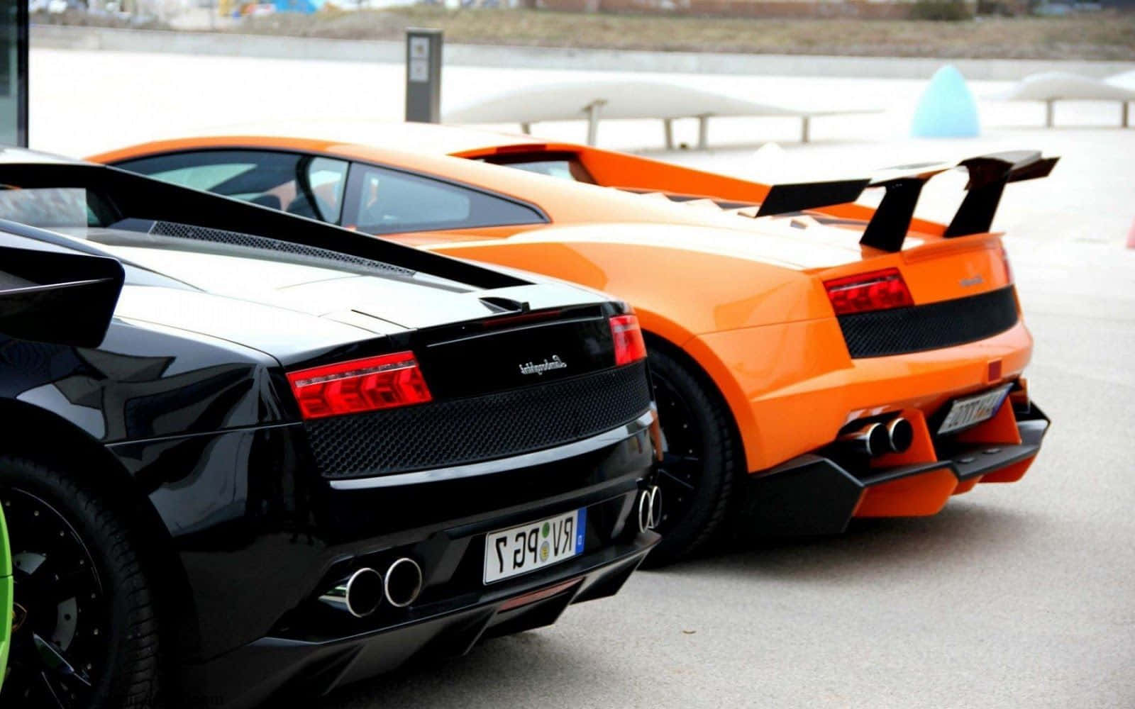 Two Lamborghinis Parked Next To Each Other