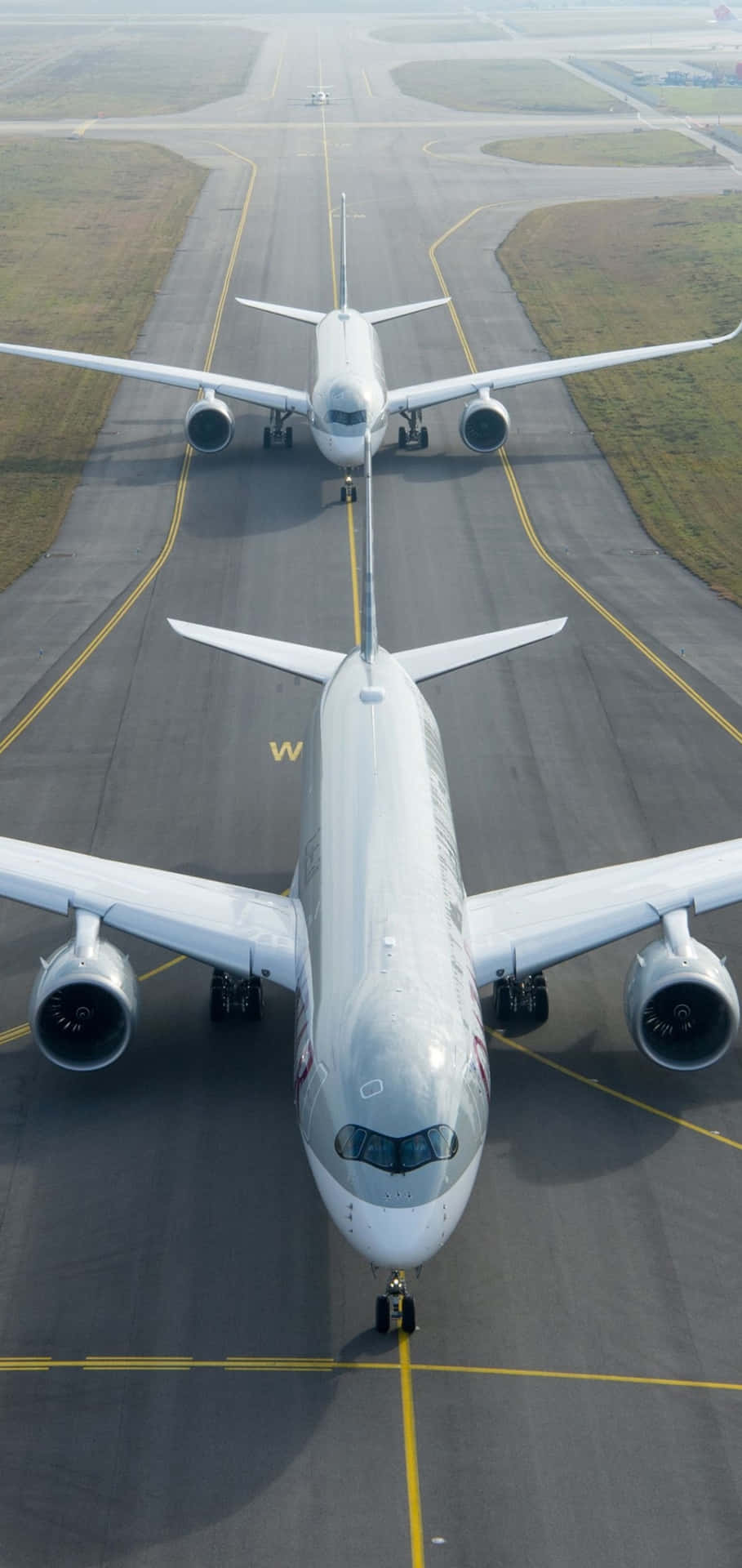 Two Large Airplanes On The Runway Background