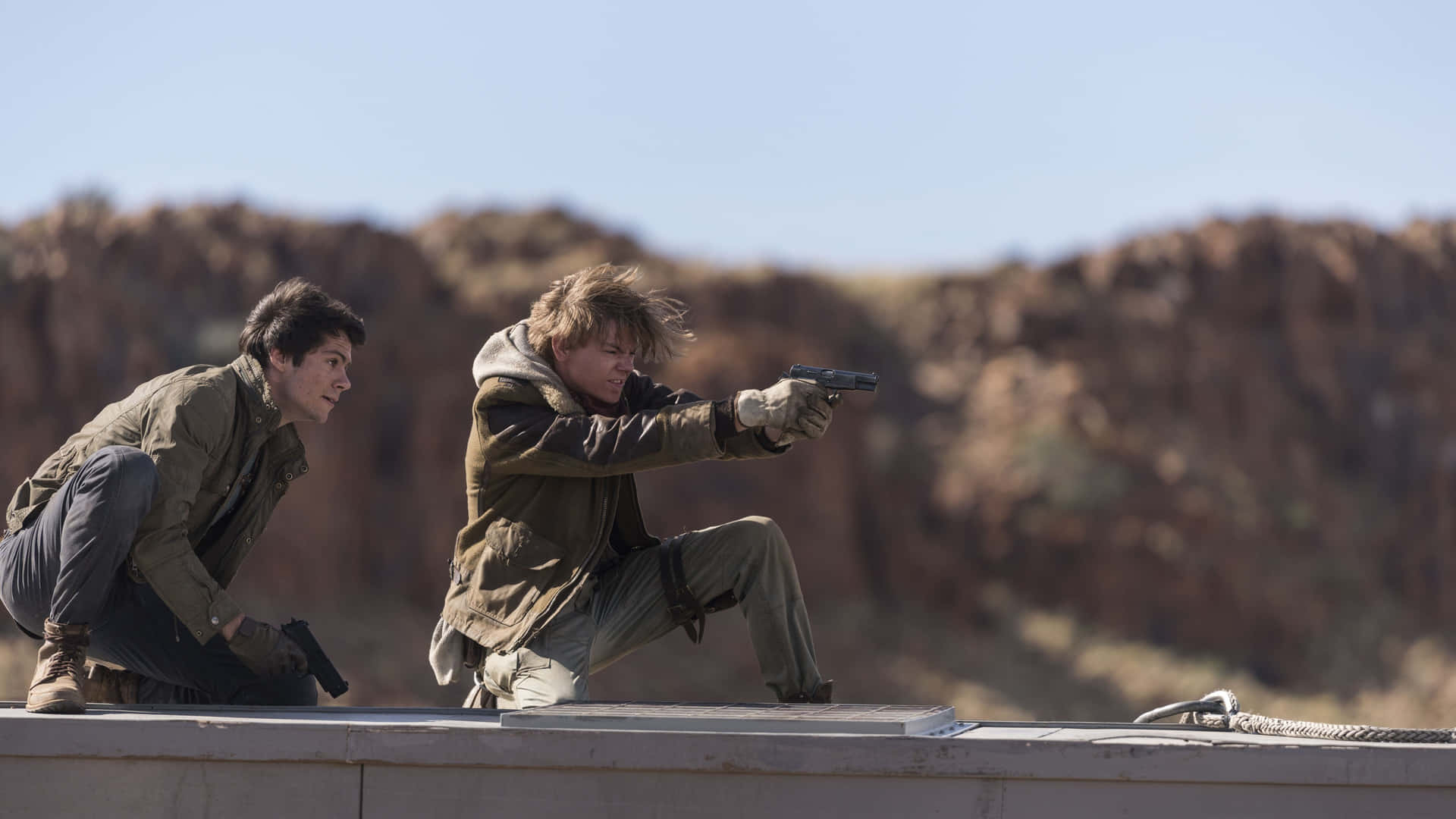 Two Men Are Pointing Guns At Each Other On A Roof Background