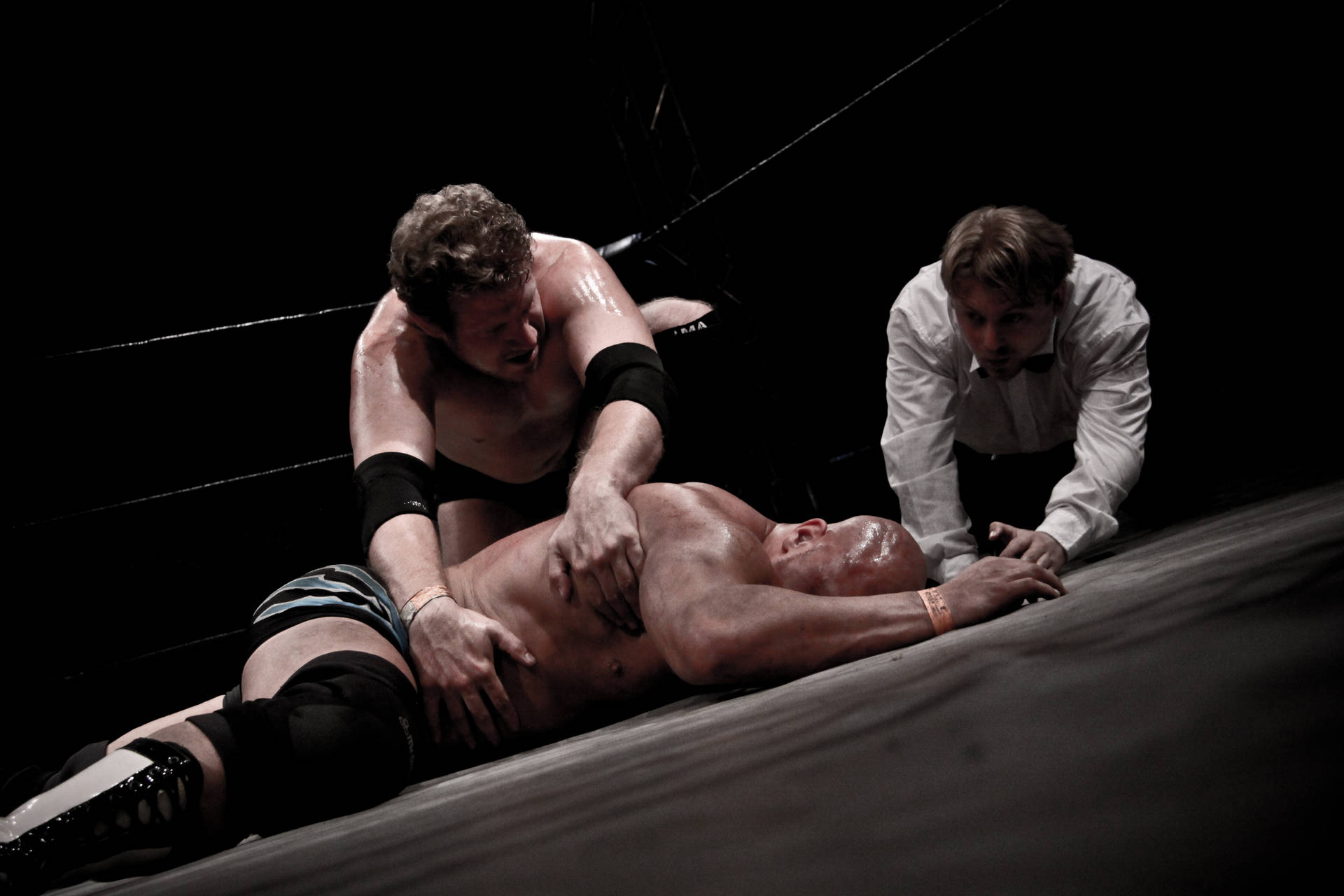 Two Men Fighting It Out In The Wrestling Ring