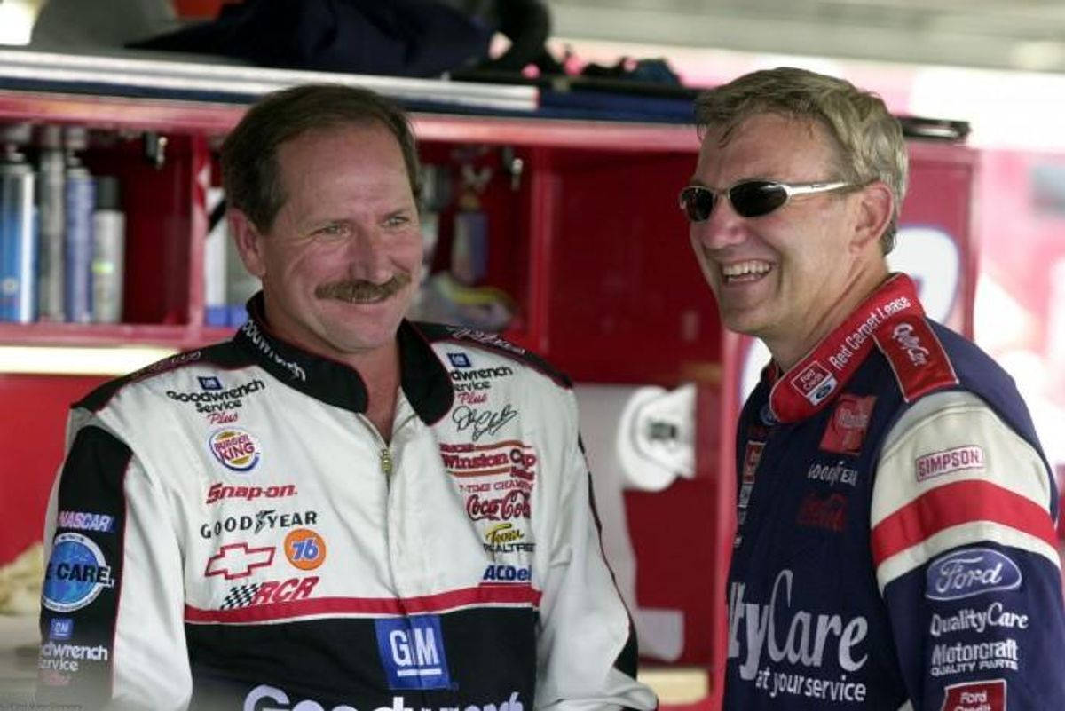 Two Men In A Nascar Uniforms Are Smiling