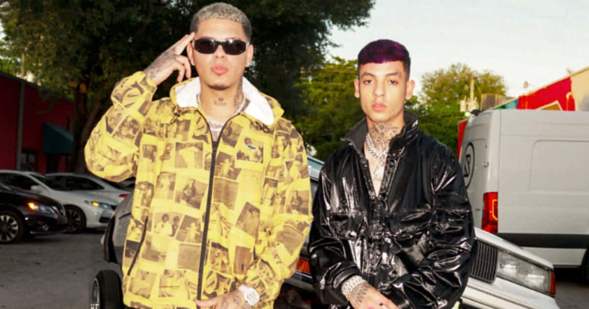 Two Men In Black Jackets Standing Next To Each Other Background