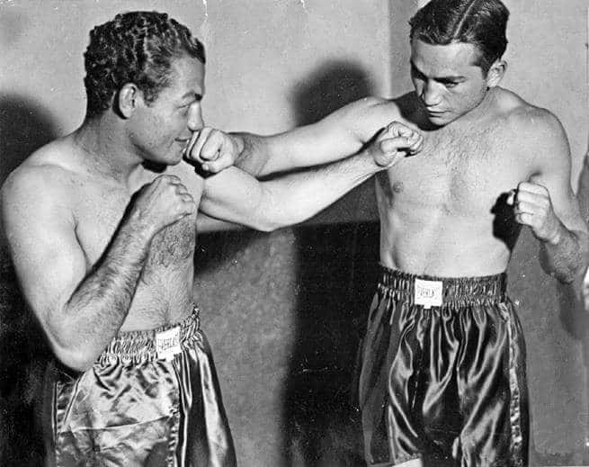 Two Men In Boxing Shorts Are Preparing For A Fight Background