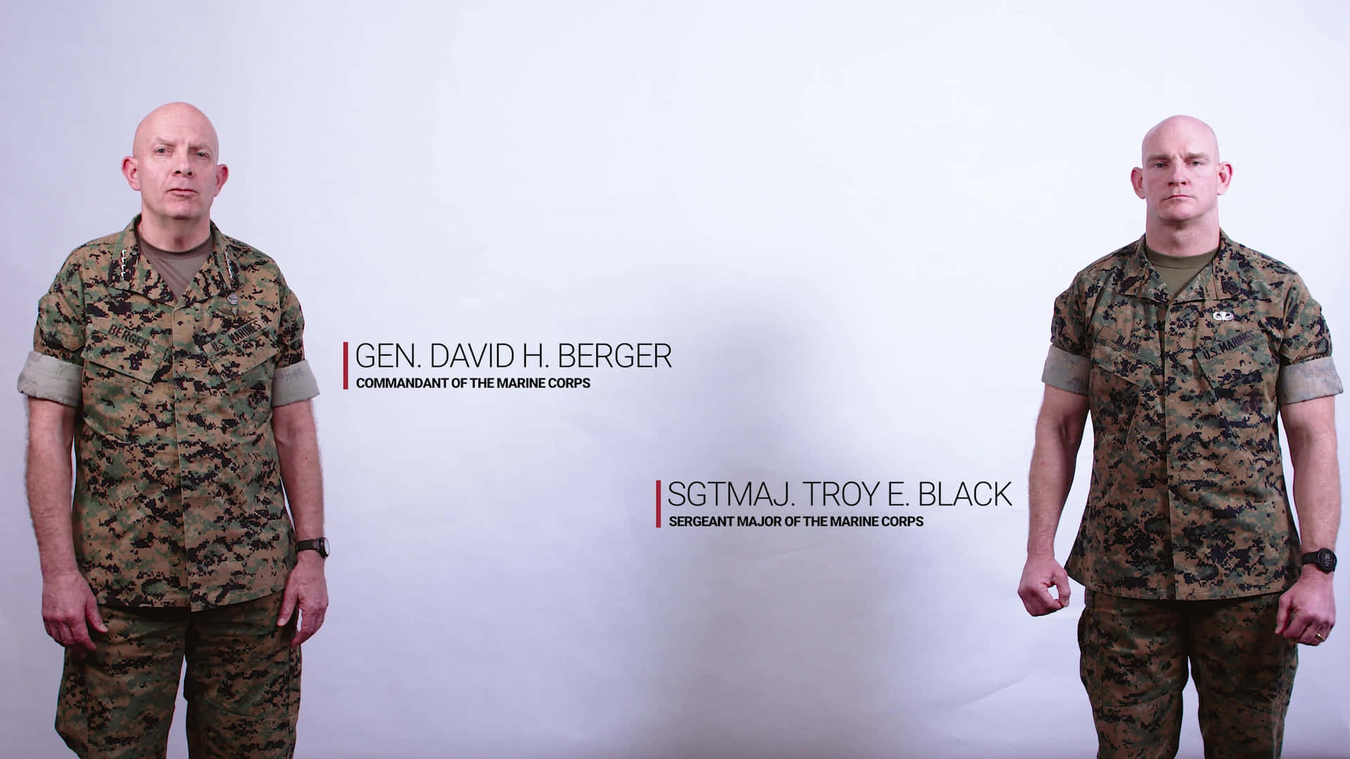 Two Men In Military Uniforms Standing Next To Each Other