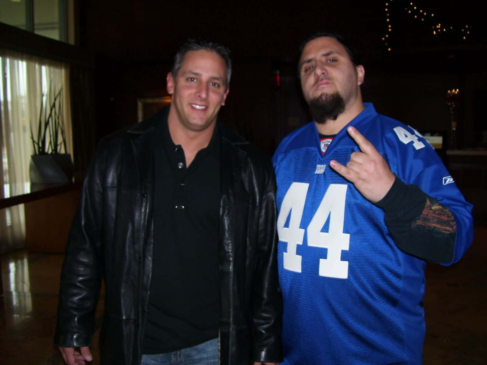 Two Men Posing Indoors Background