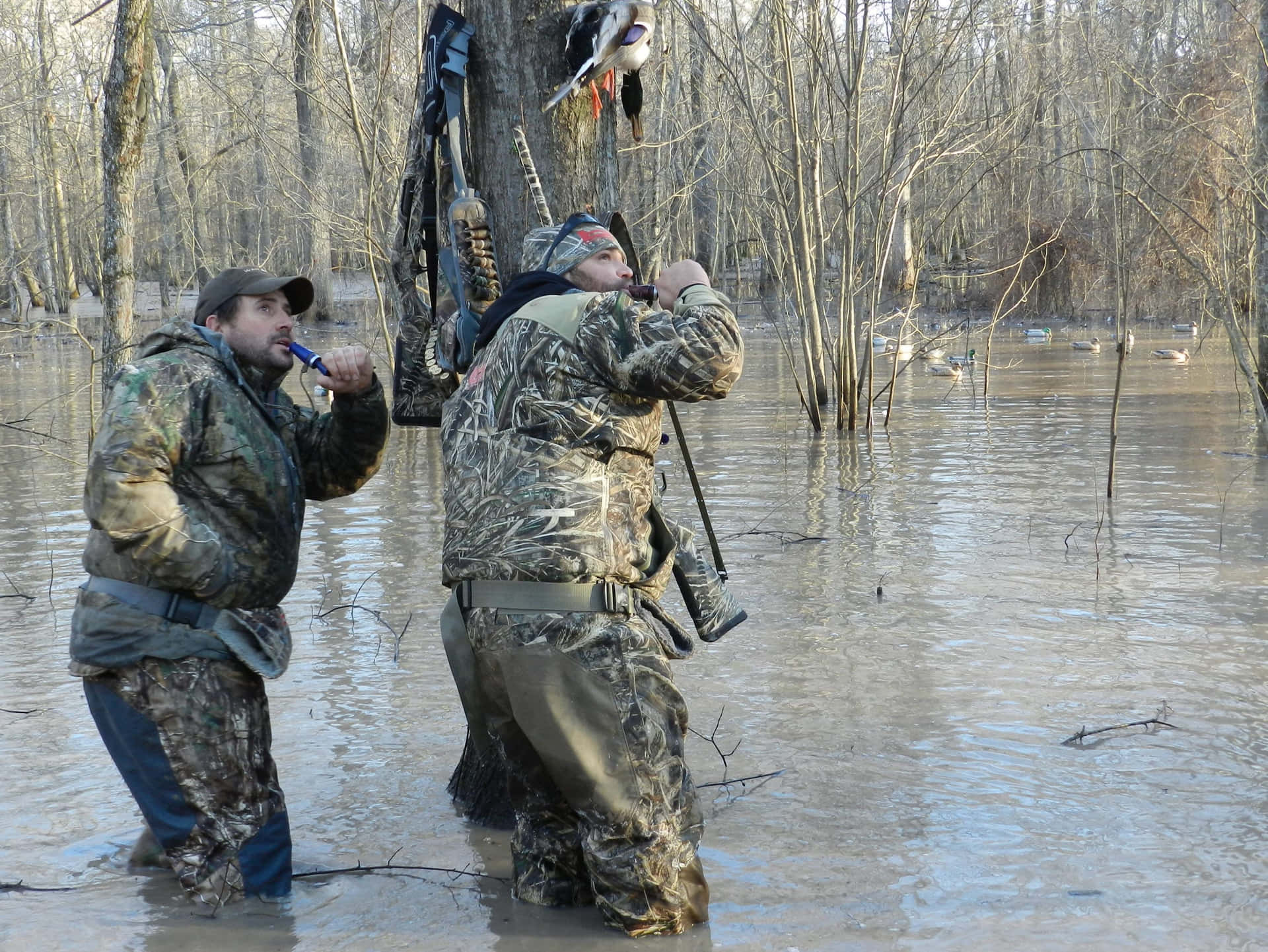 Two Men Standing In A Flooded Area