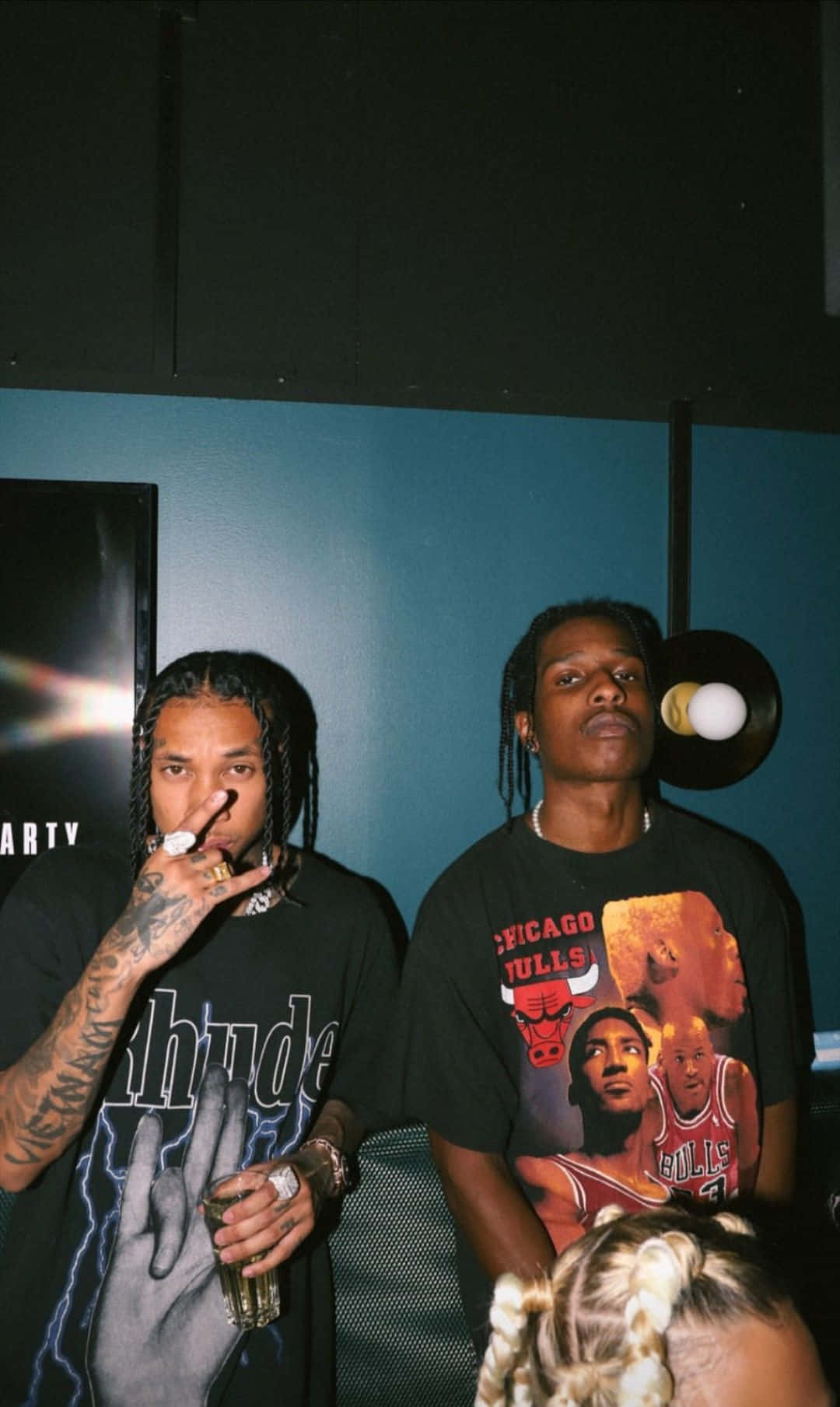 Two Men Standing Next To Each Other In A Room Background