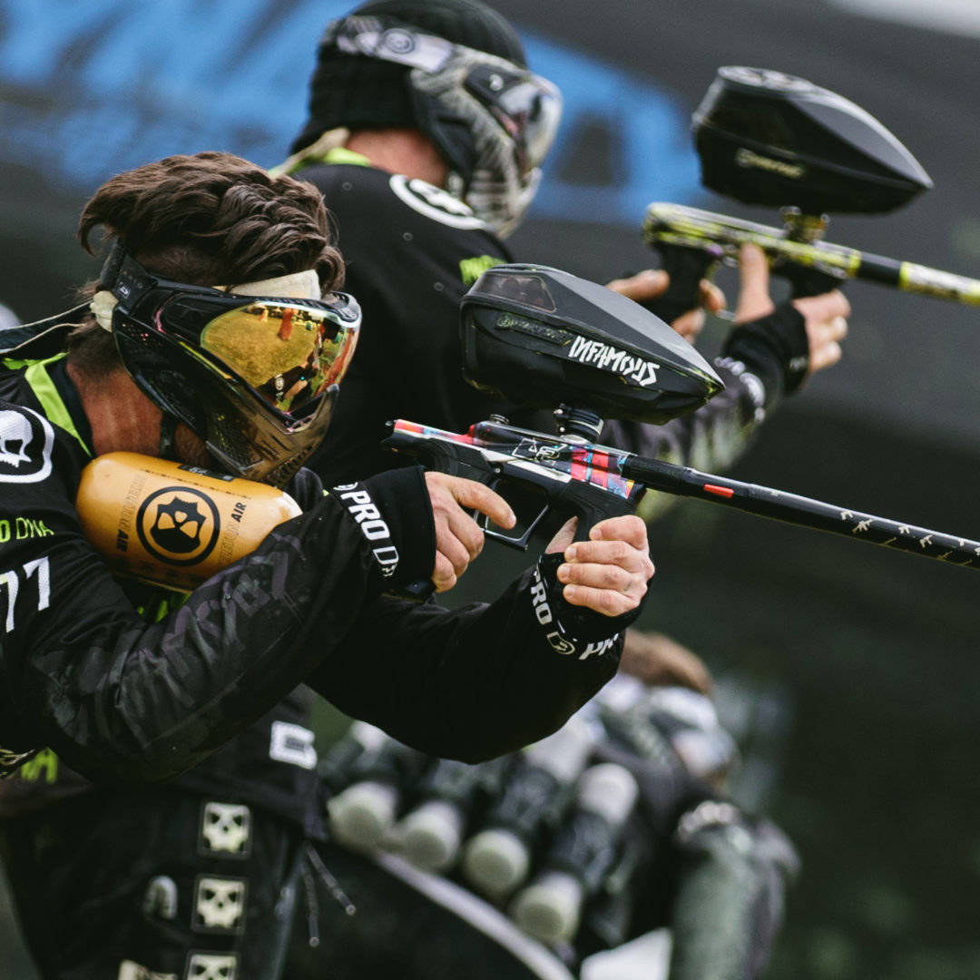 Two Paintball Players In Black