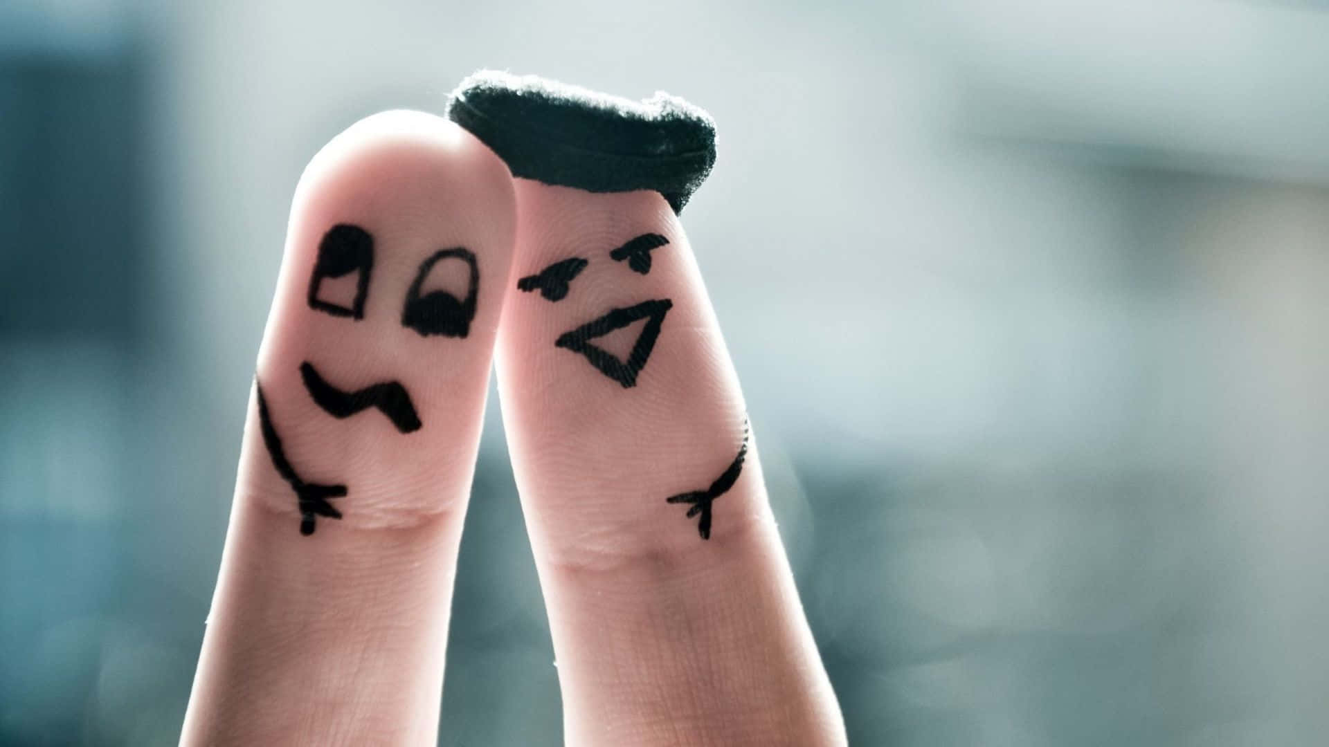 Two People Holding Their Fingers Up With Faces Drawn On Them Background