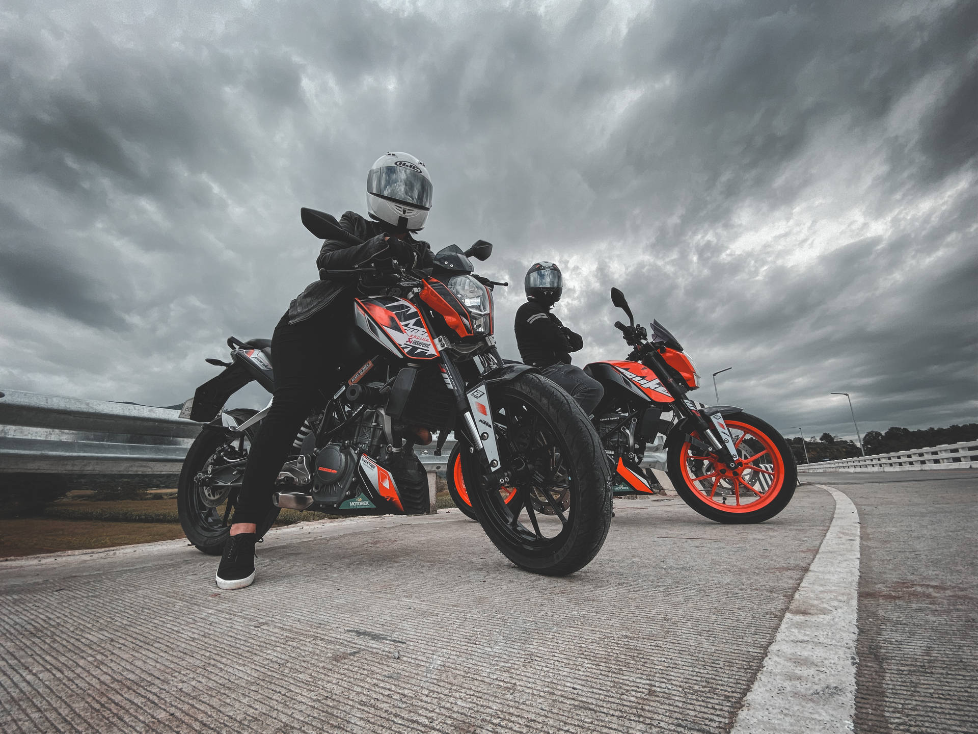 Two People Sitting On Ktm Duke 200