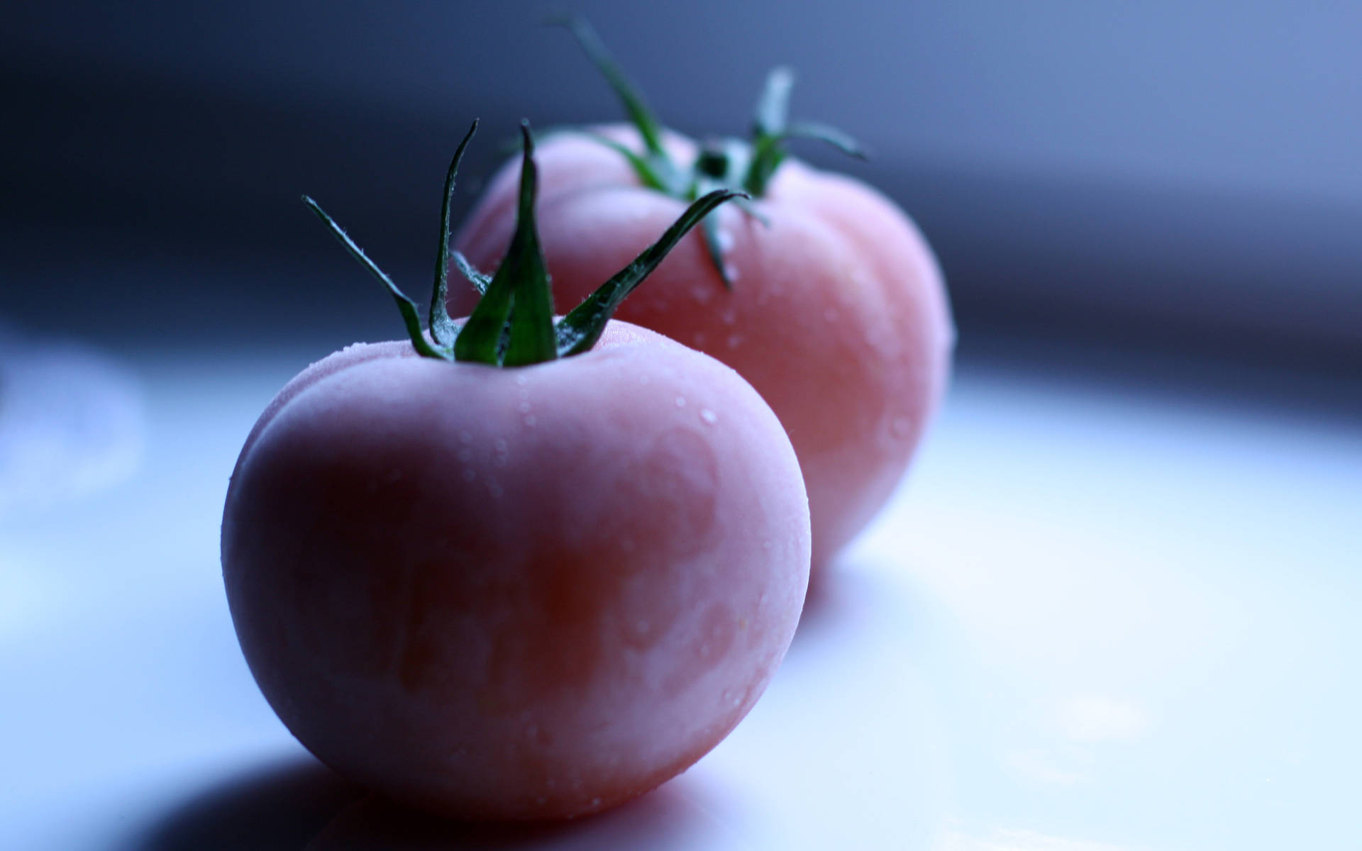 Two Pink Frozen Tomato Fruits Background