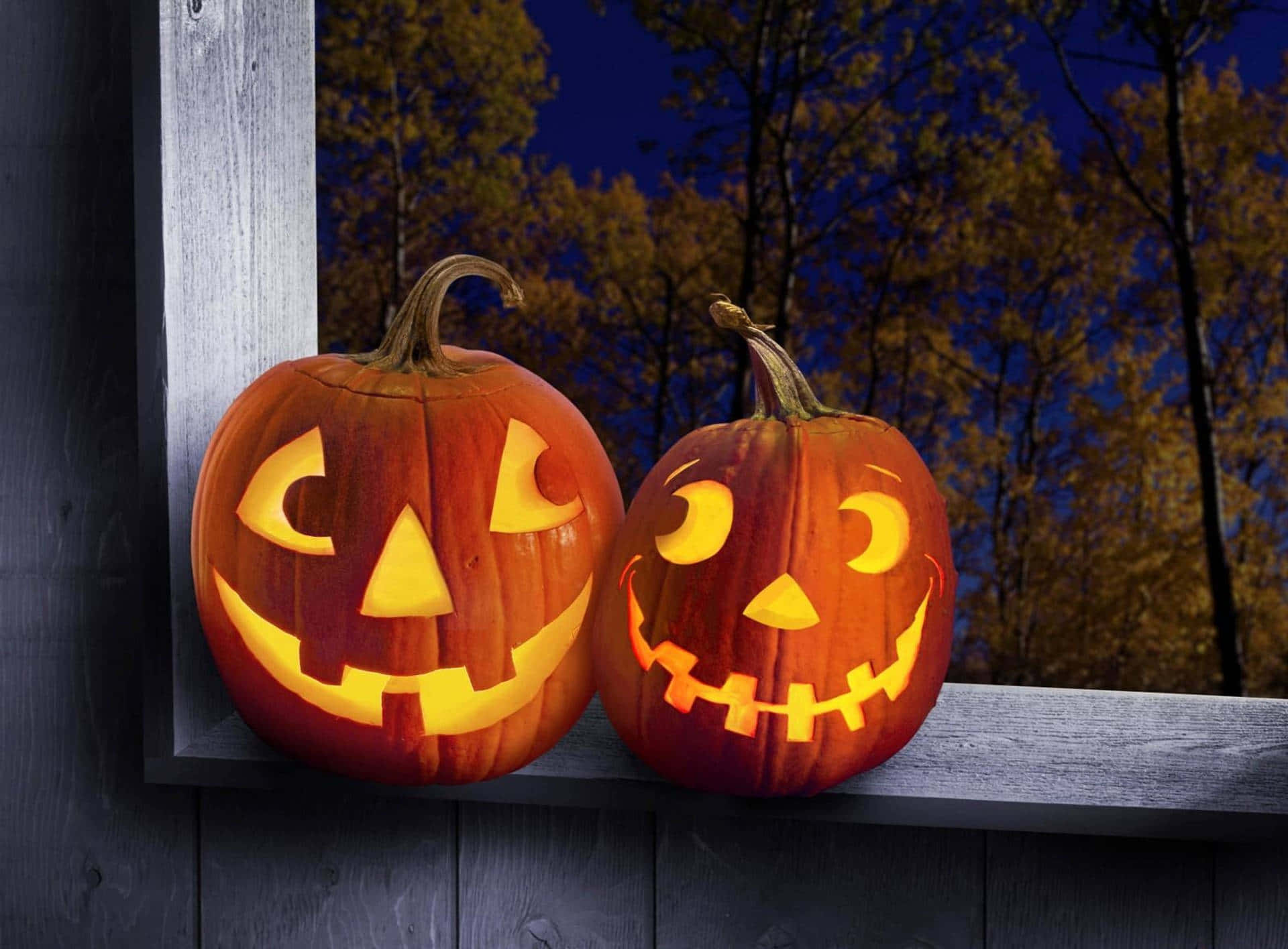 Two Pumpkins With Faces On Them Sit On A Window Sill Background