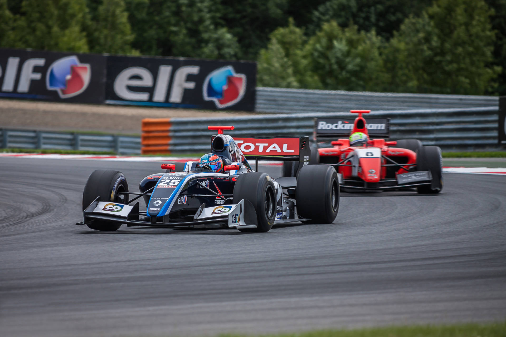 Two Racing Cars On A Track Background