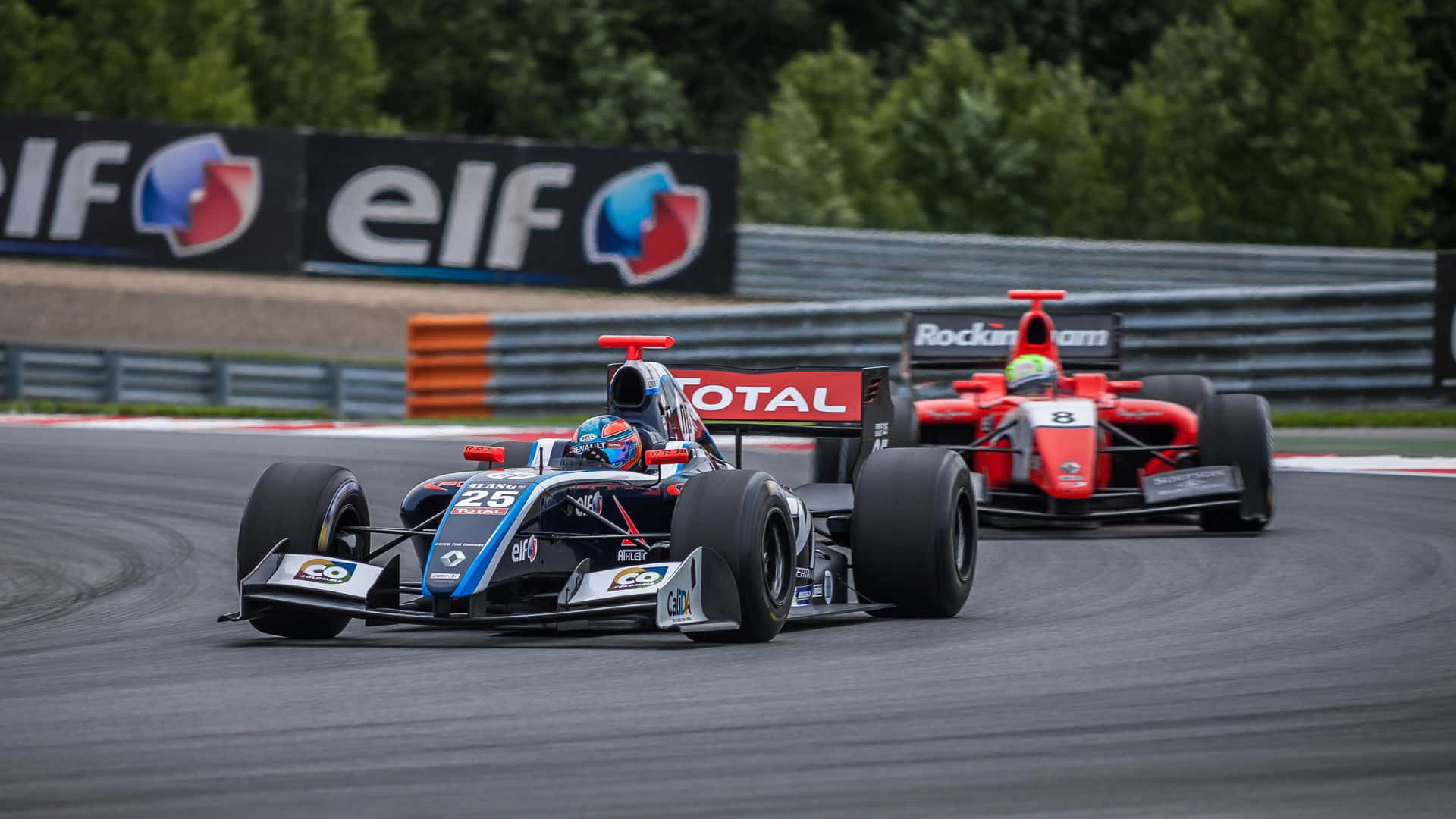 Two Racing Cars On A Track With A Sign Background