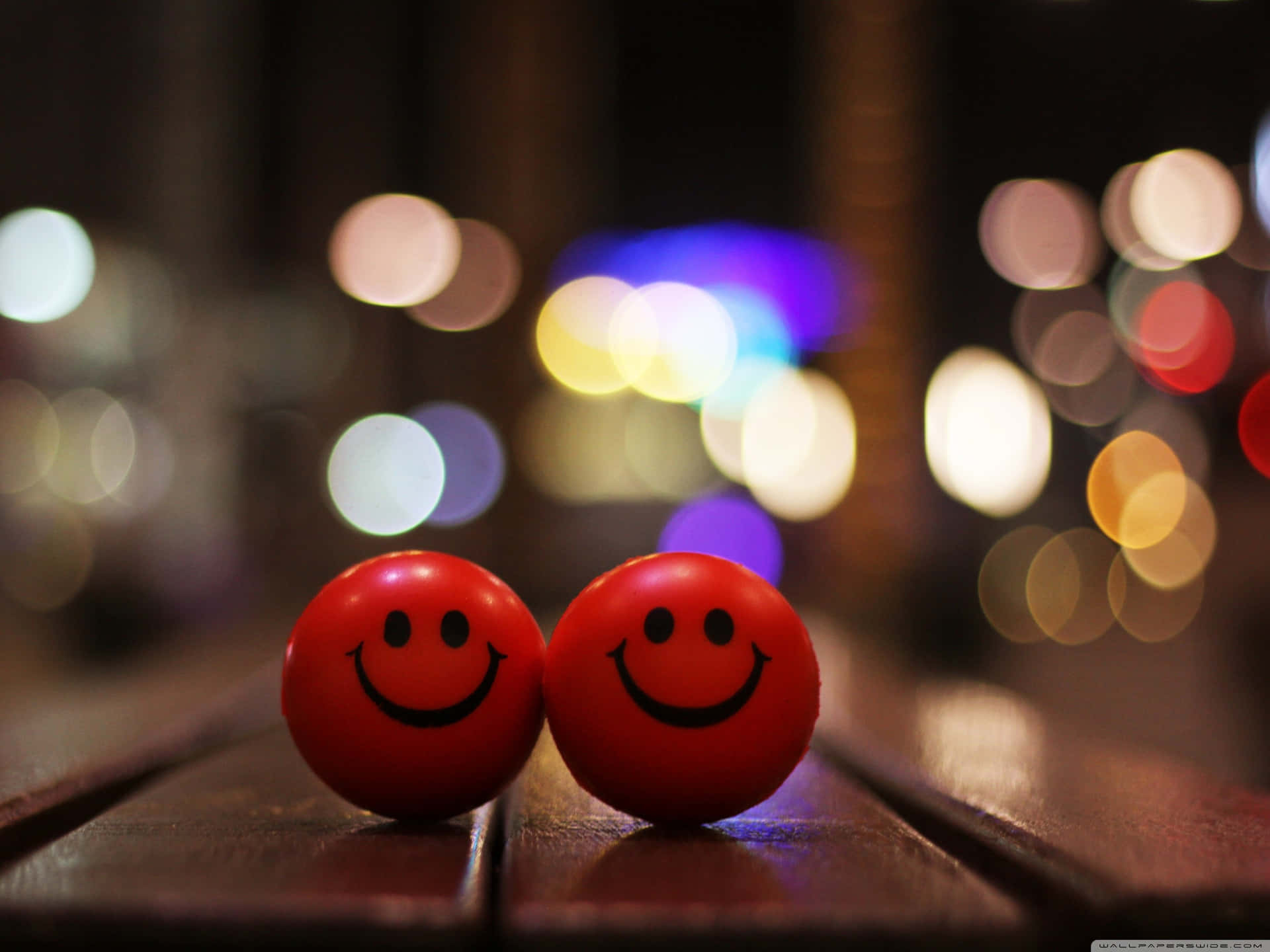 Two Red Balls On A Wooden Table Background