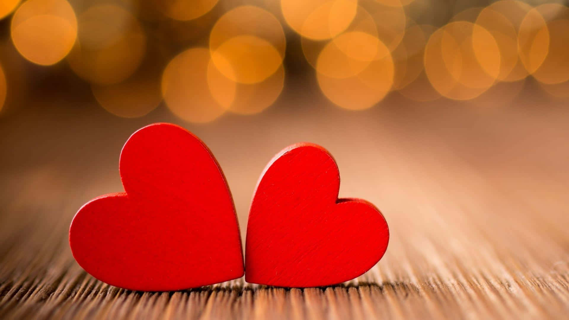 Two Red Hearts On A Wooden Table With Bokeh Background Background