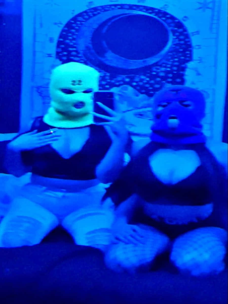 Two Ski Mask Girl Models Taking Selfie On Bed Background