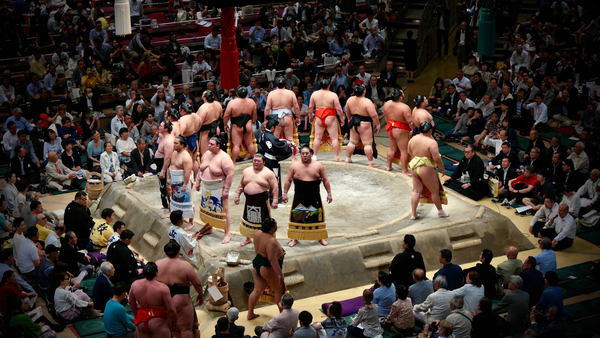 Two Sumo Wrestlers Clash In A Traditional Japanese Arena