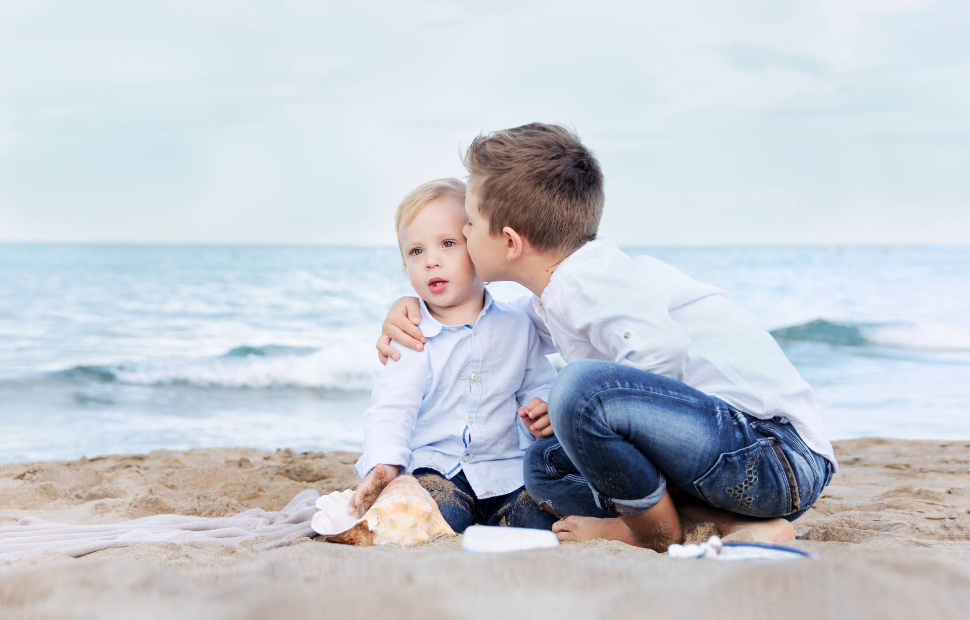 Two Toddler Boys On The Sand Background