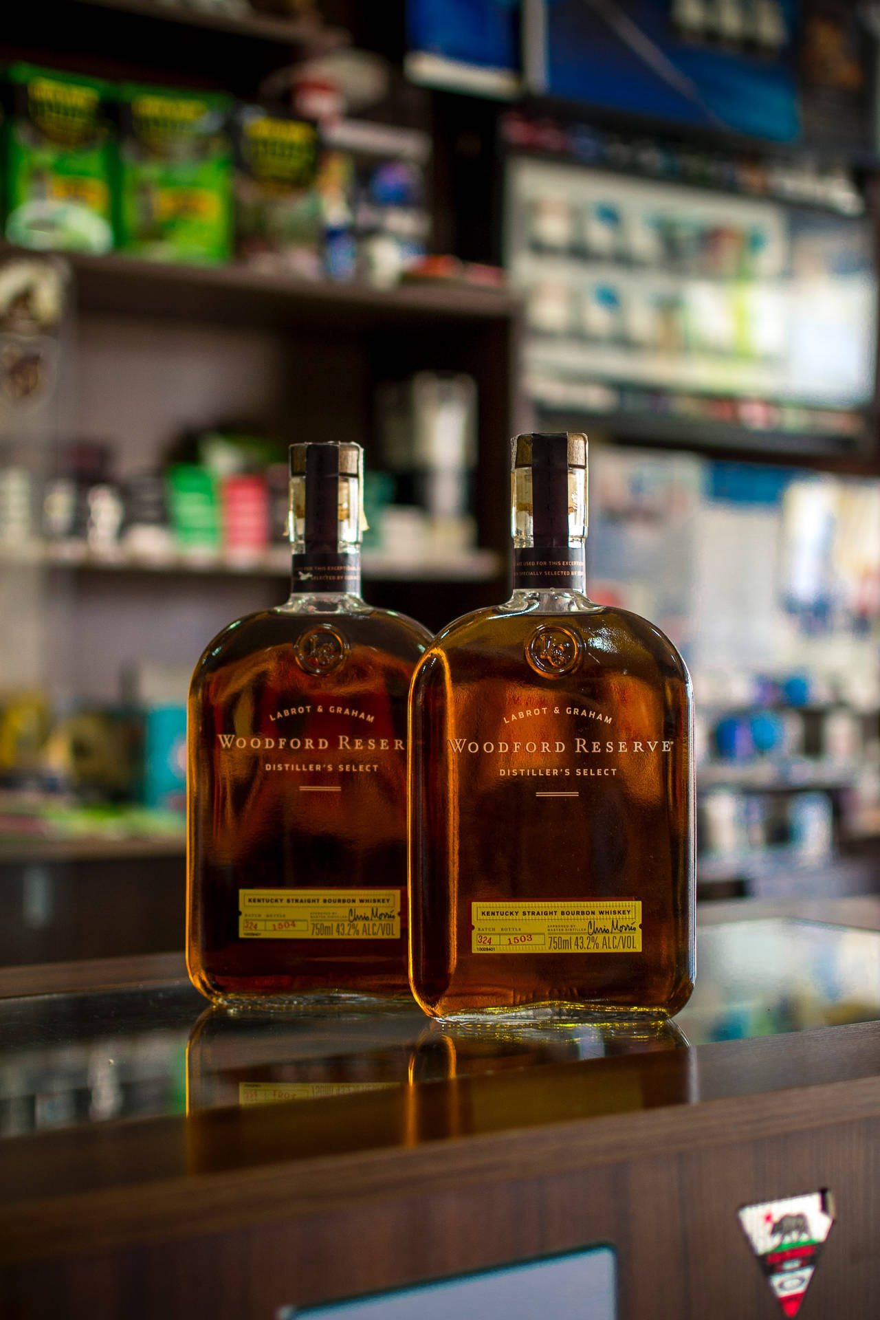 Two Whiskey Bottles On Bar Counter