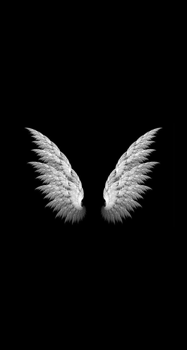 Two White Angel Wings On A Black Background