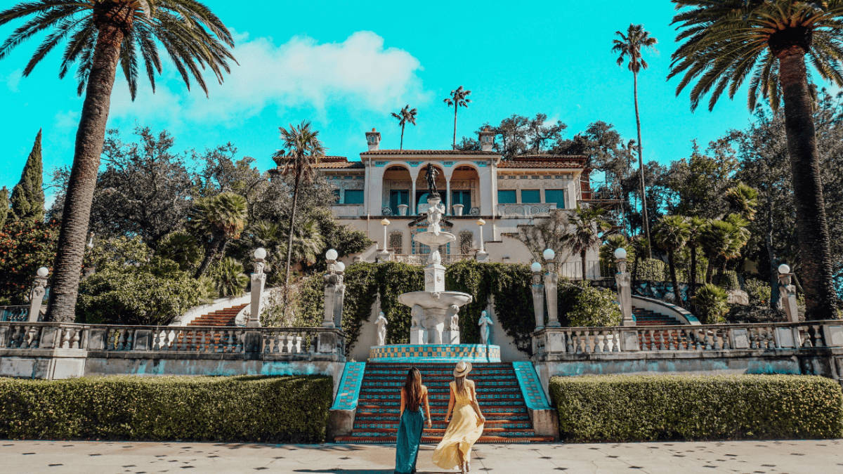 Two Women Entering The Hearst Castle Background