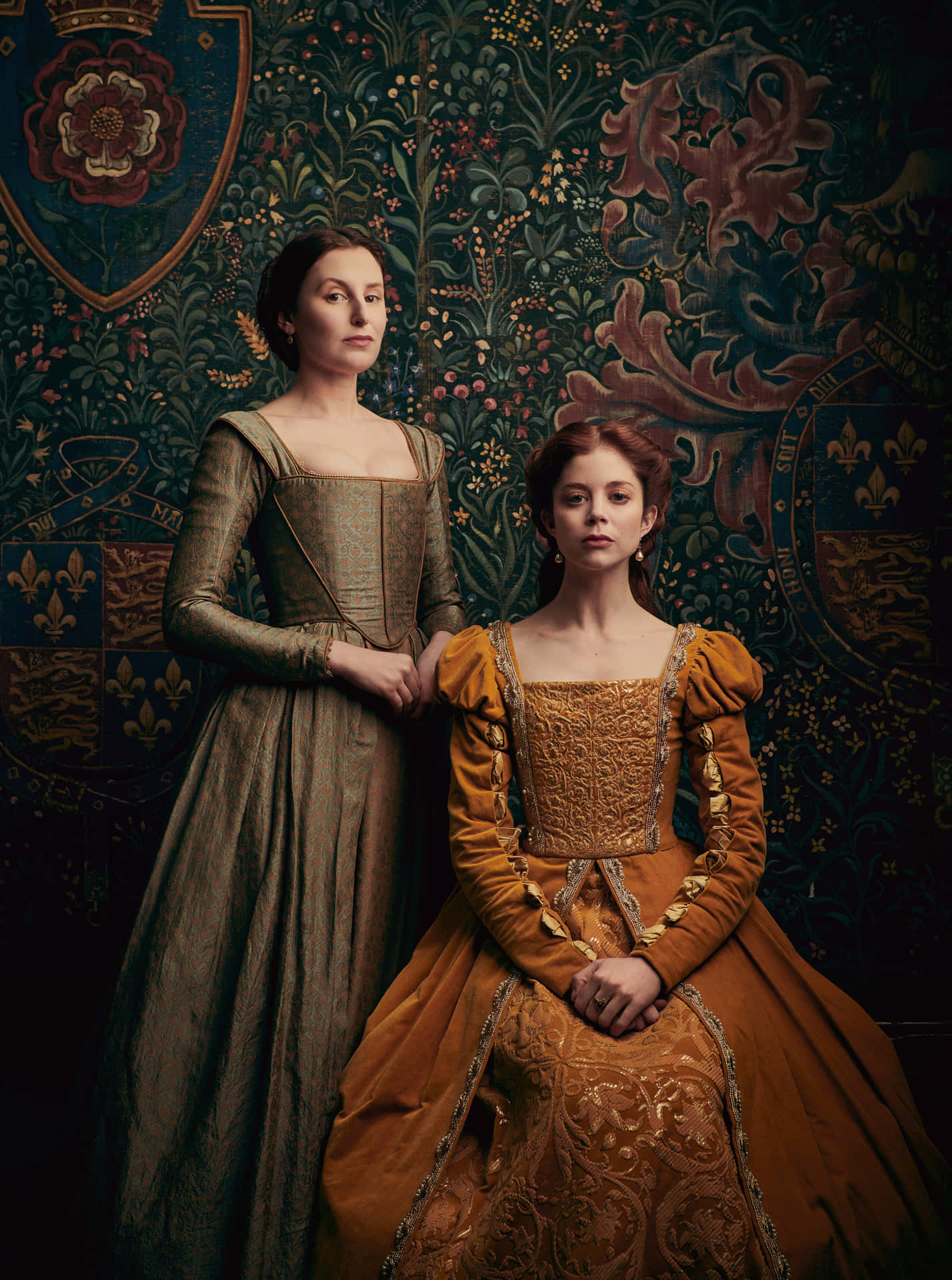 Two Women In Renaissance Dresses Posing For A Photo