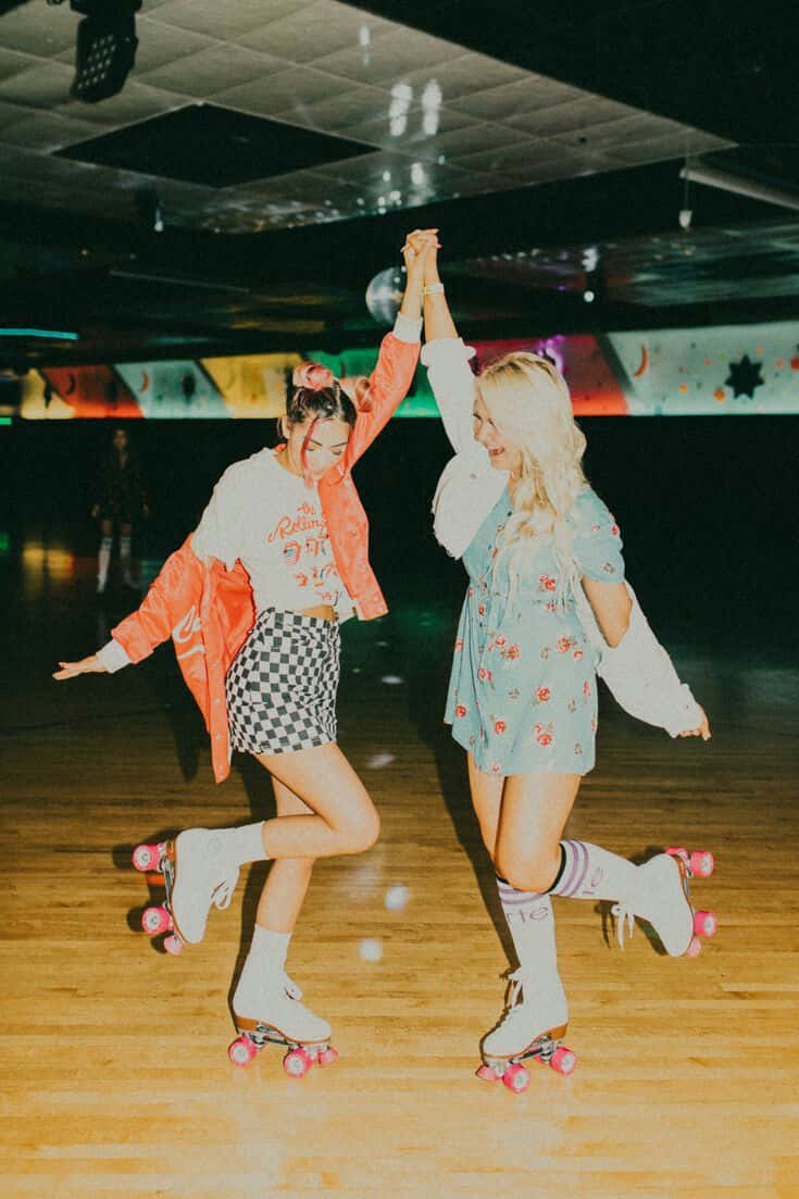Two Women Rollerblading In A Roller Rink
