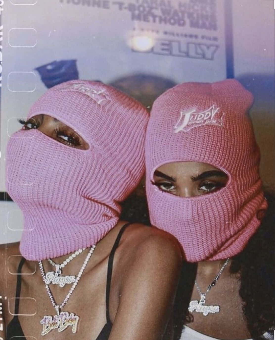 Two Women Wearing Pink Hats And A Necklace Background
