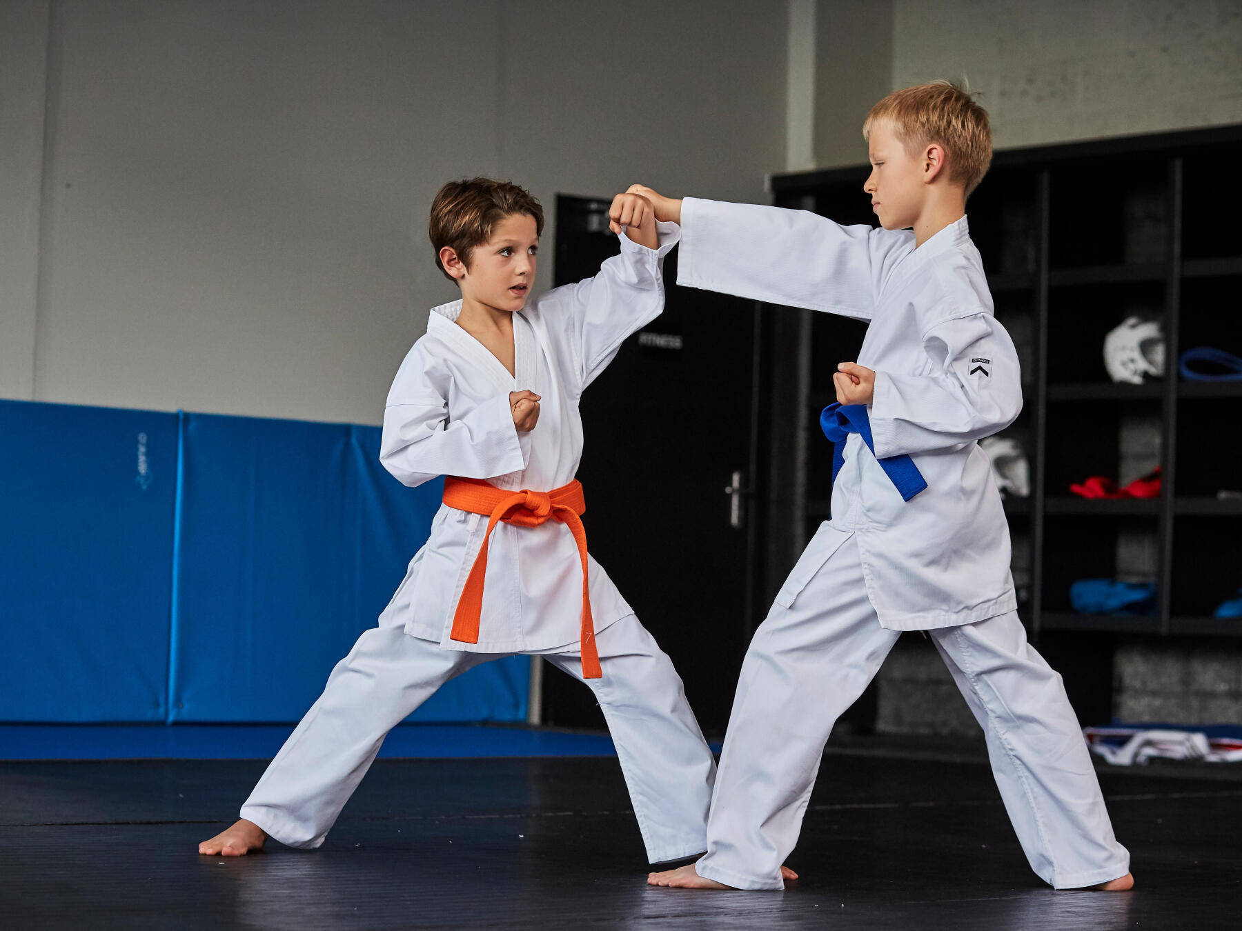 Two Young Karate Students Showcasing Their Skills Background