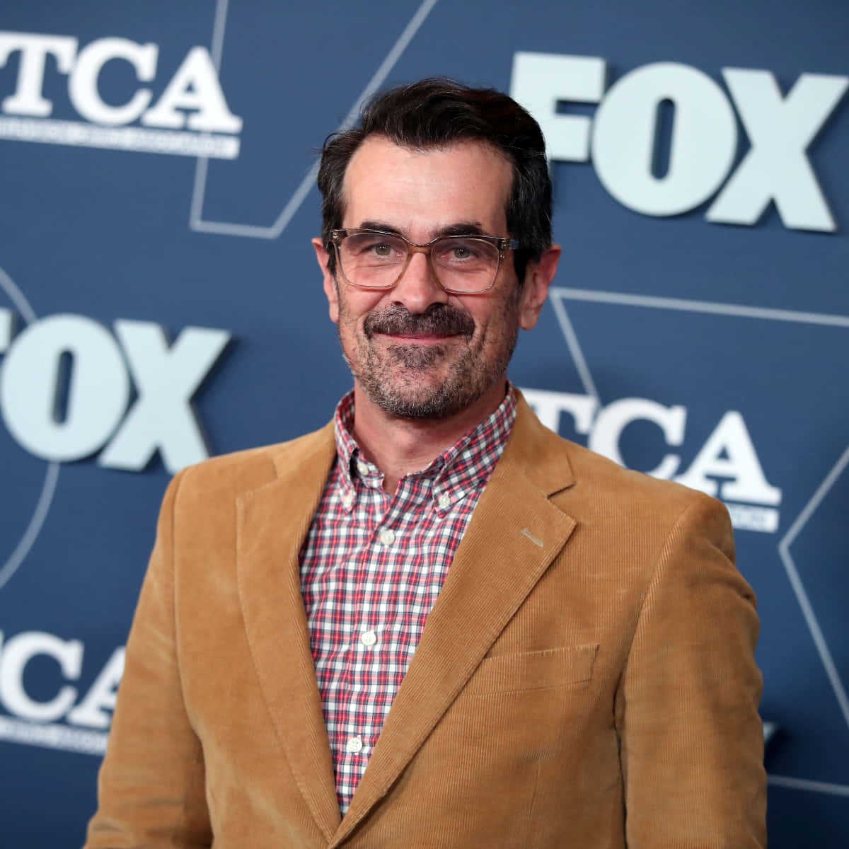 Ty Burrell Smiling Elegantly Background