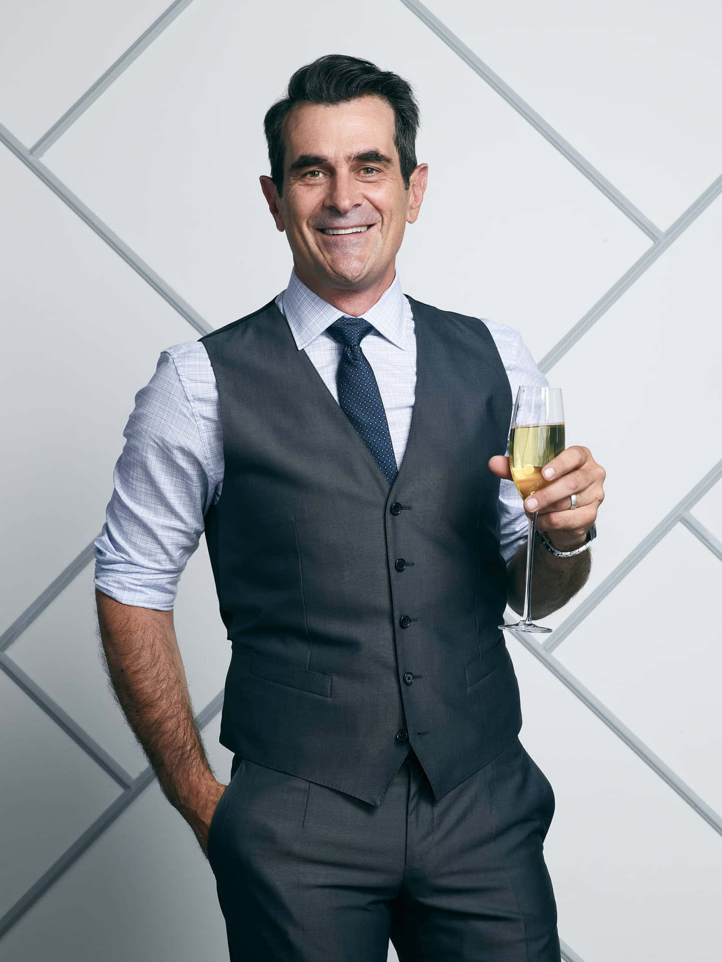 Ty Burrell, Smiling In A Black Suit And Tie Background
