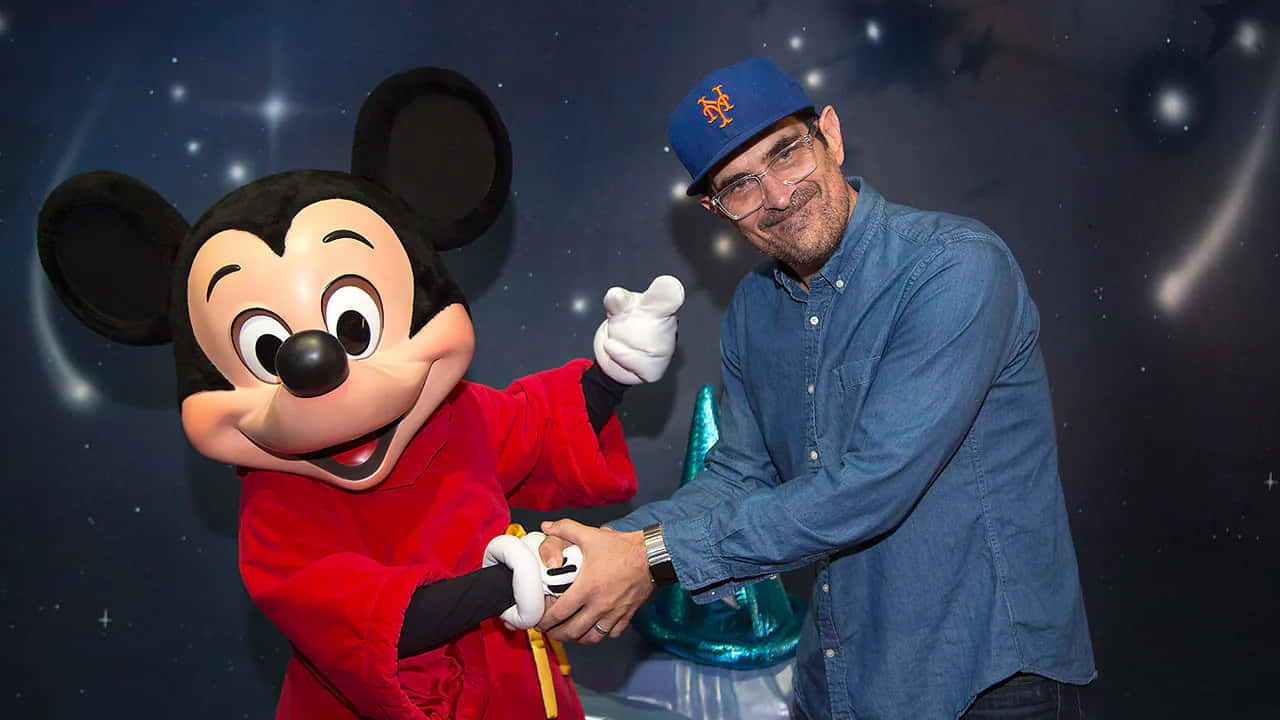 Ty Burrell Smiling On A Red Carpet Background