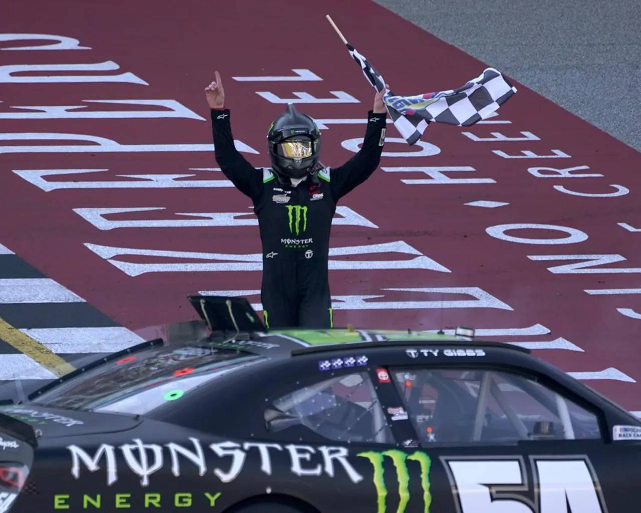 Ty Gibbs Holding The Checkered Flag Background