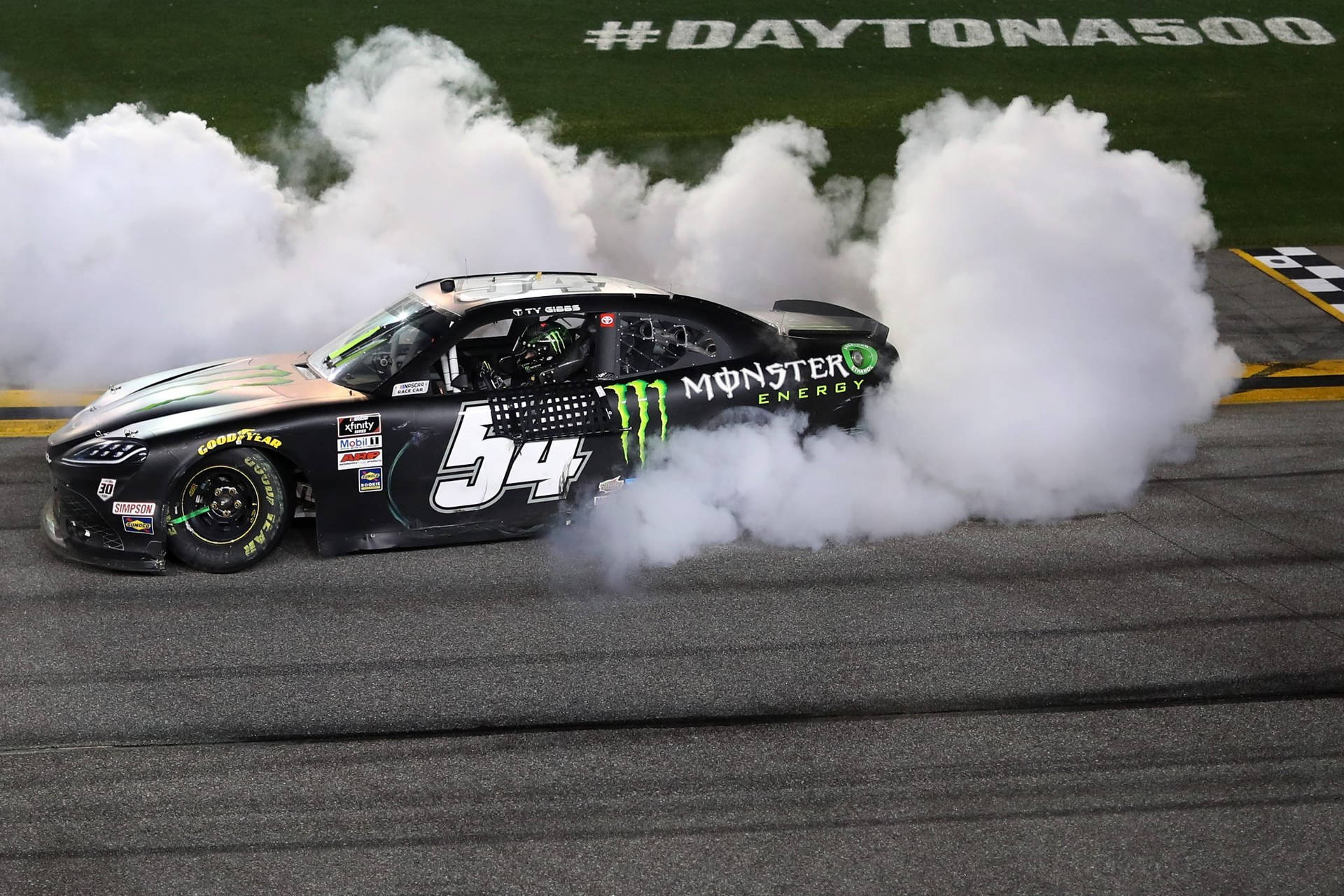 Ty Gibbs Victoriously Smoking Tires At Daytona 500 Background