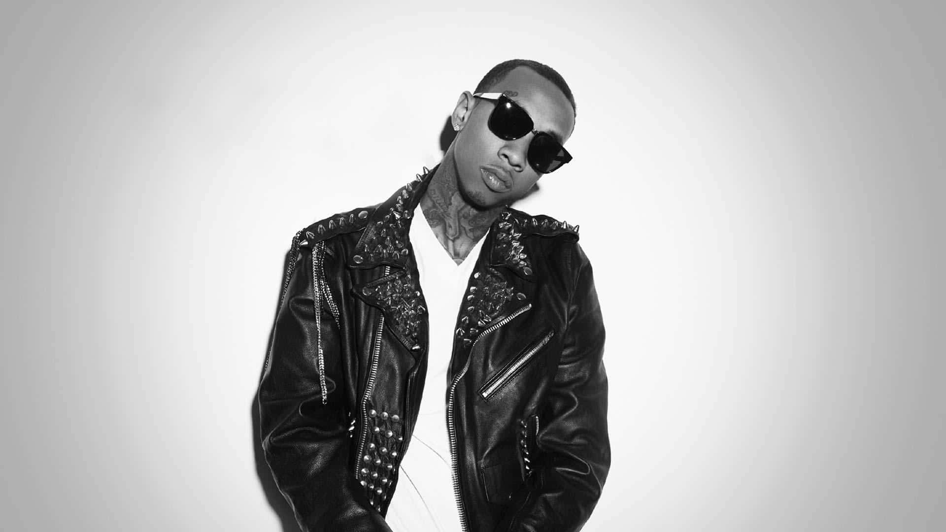 Tyga Rap Star Rocking The Red Hat On Stage Background