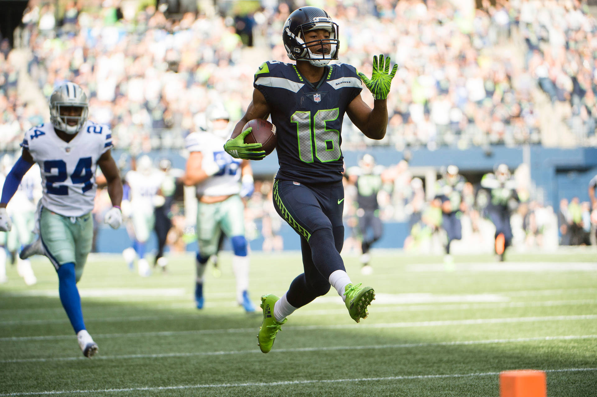 Tyler Lockett In Action On The Football Field Background