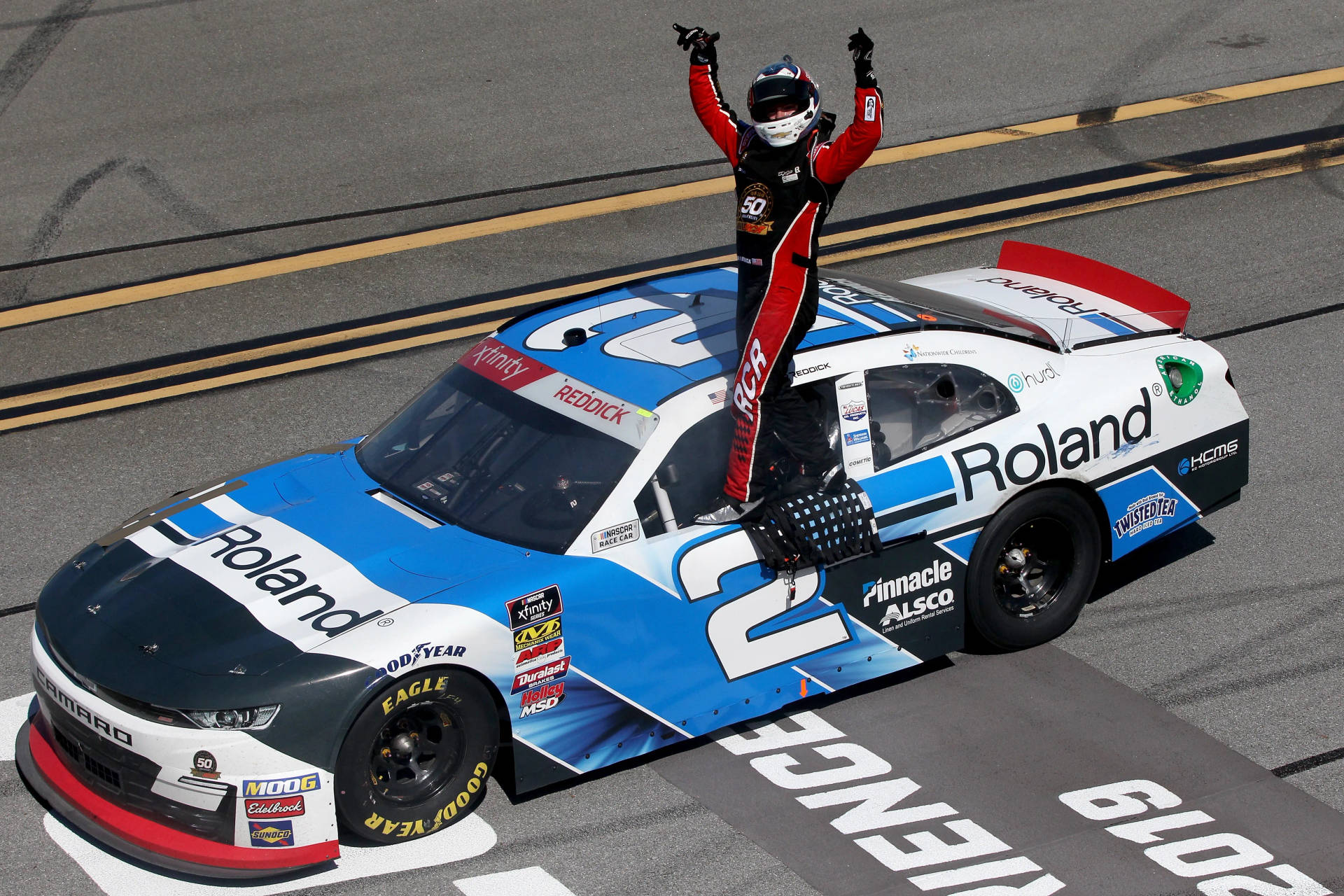 Tyler Reddick Standing On The Window Background