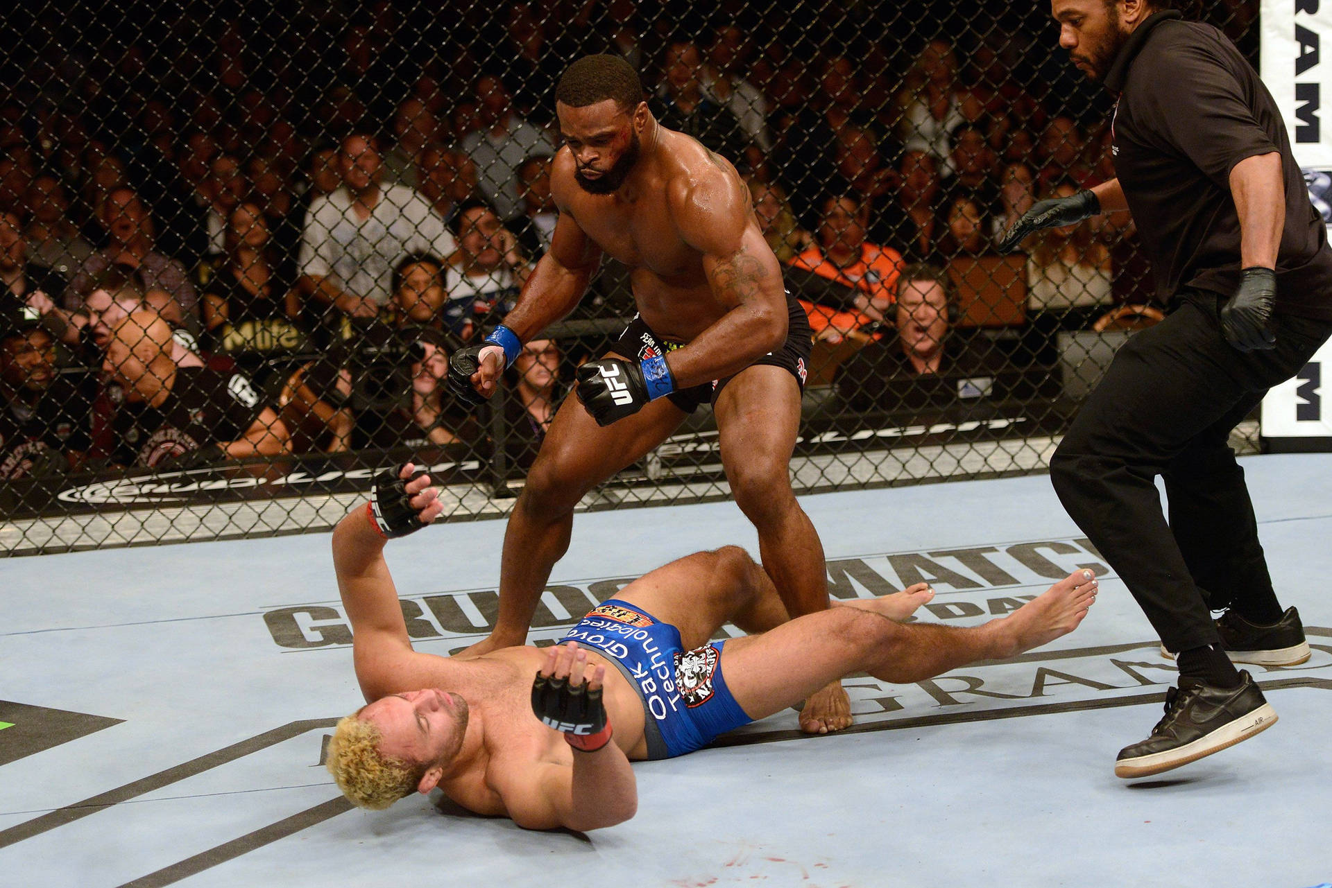 Tyron Woodley Landing A Knockout Punch On His Opponent Background