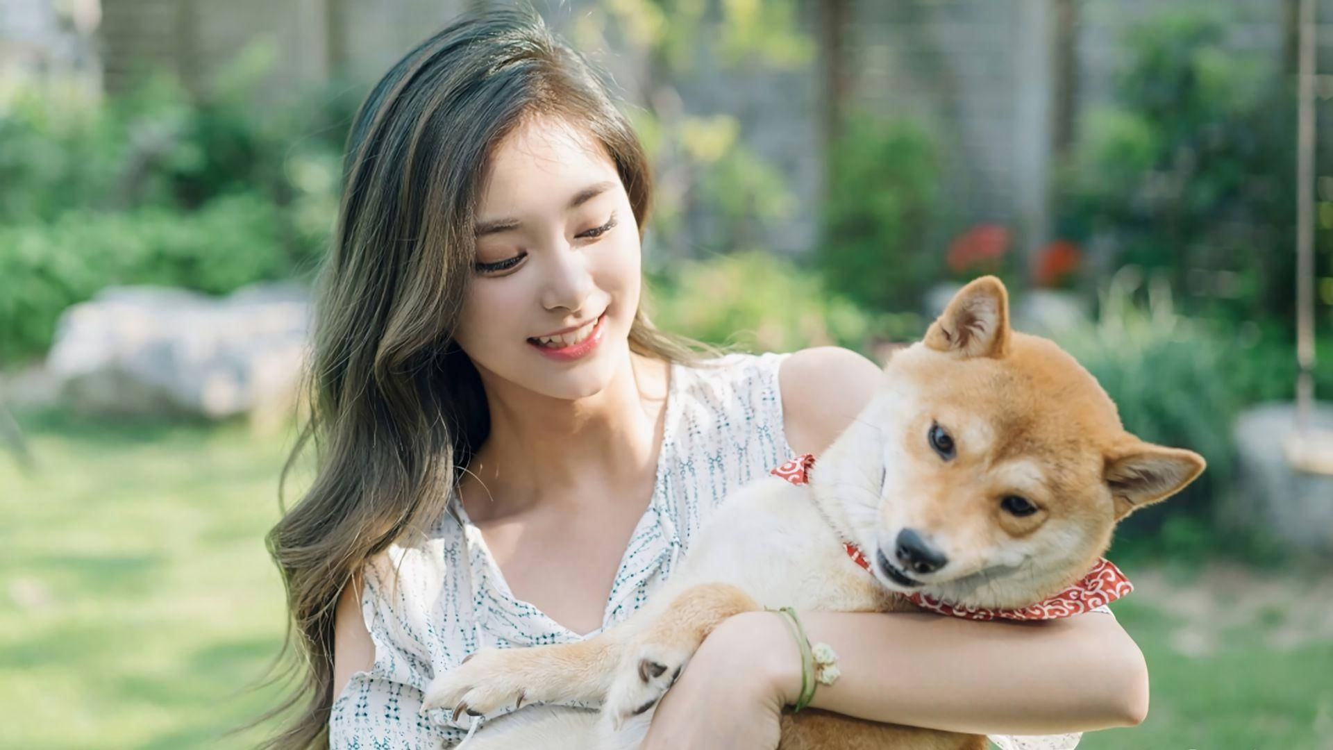 Tzuyu Holding A Cute Dog Background