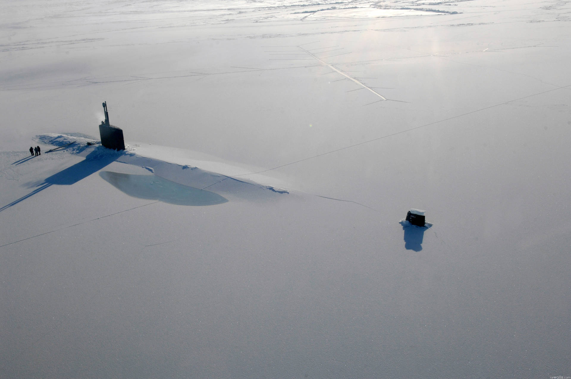 U S Navy Submarine Breaking Through Ice Background