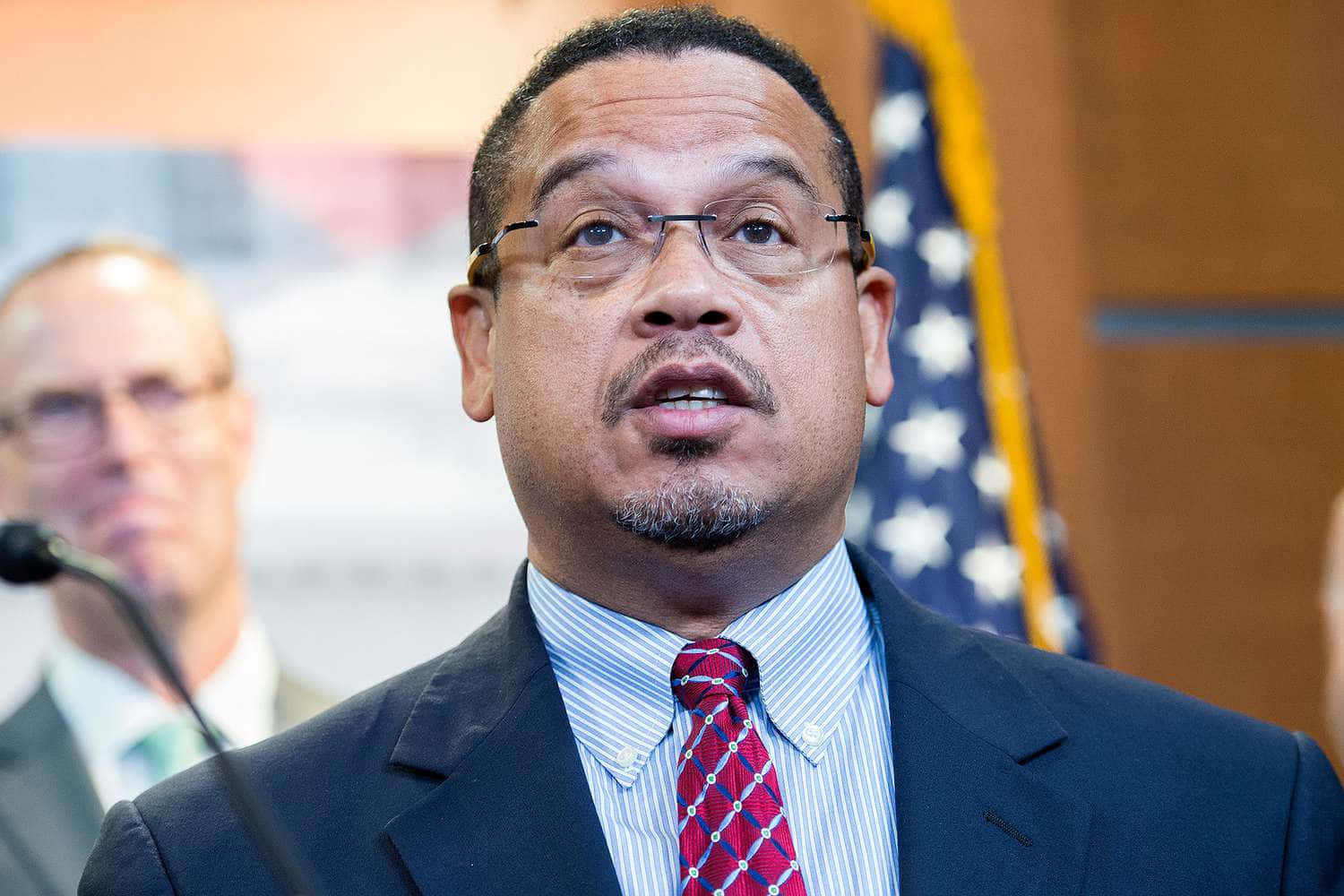 U.s. Representative Keith Ellison Reflectively Looking Up Background