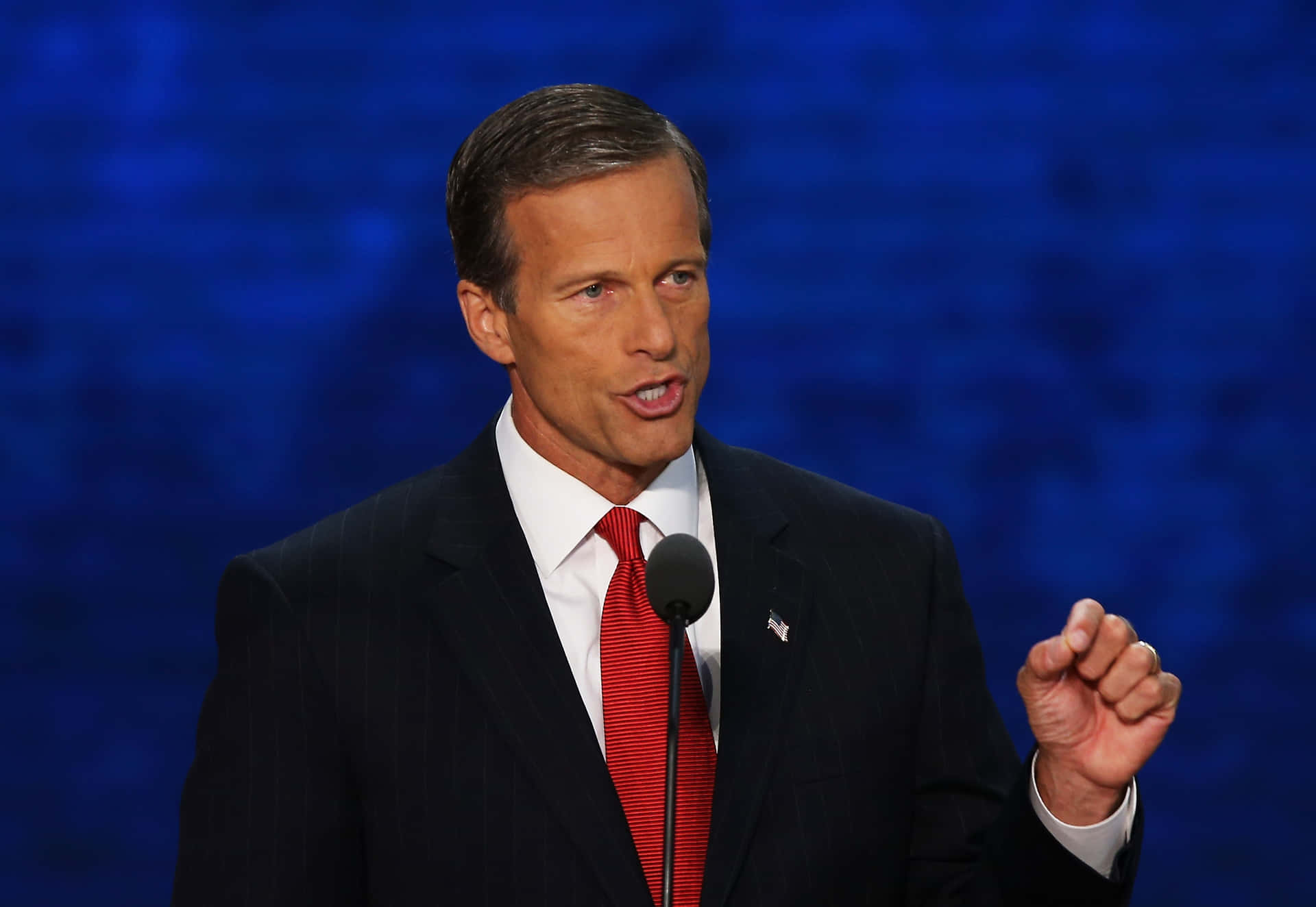 U.s. Senator John Thune In Formal Attire With A Dark Blue Background. Background