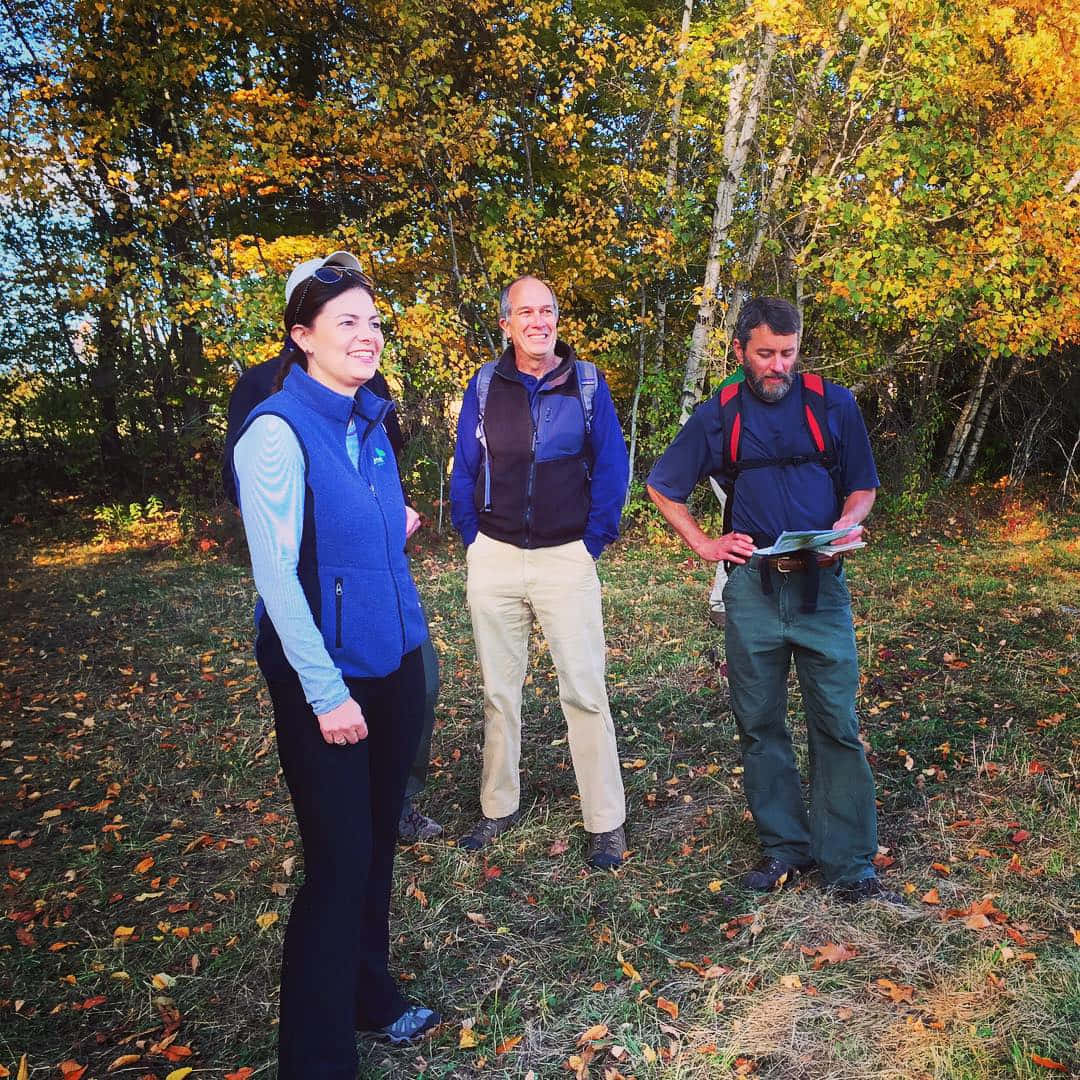 U.s. Senator Kelly Ayotte Stands In A Peaceful Forest Background