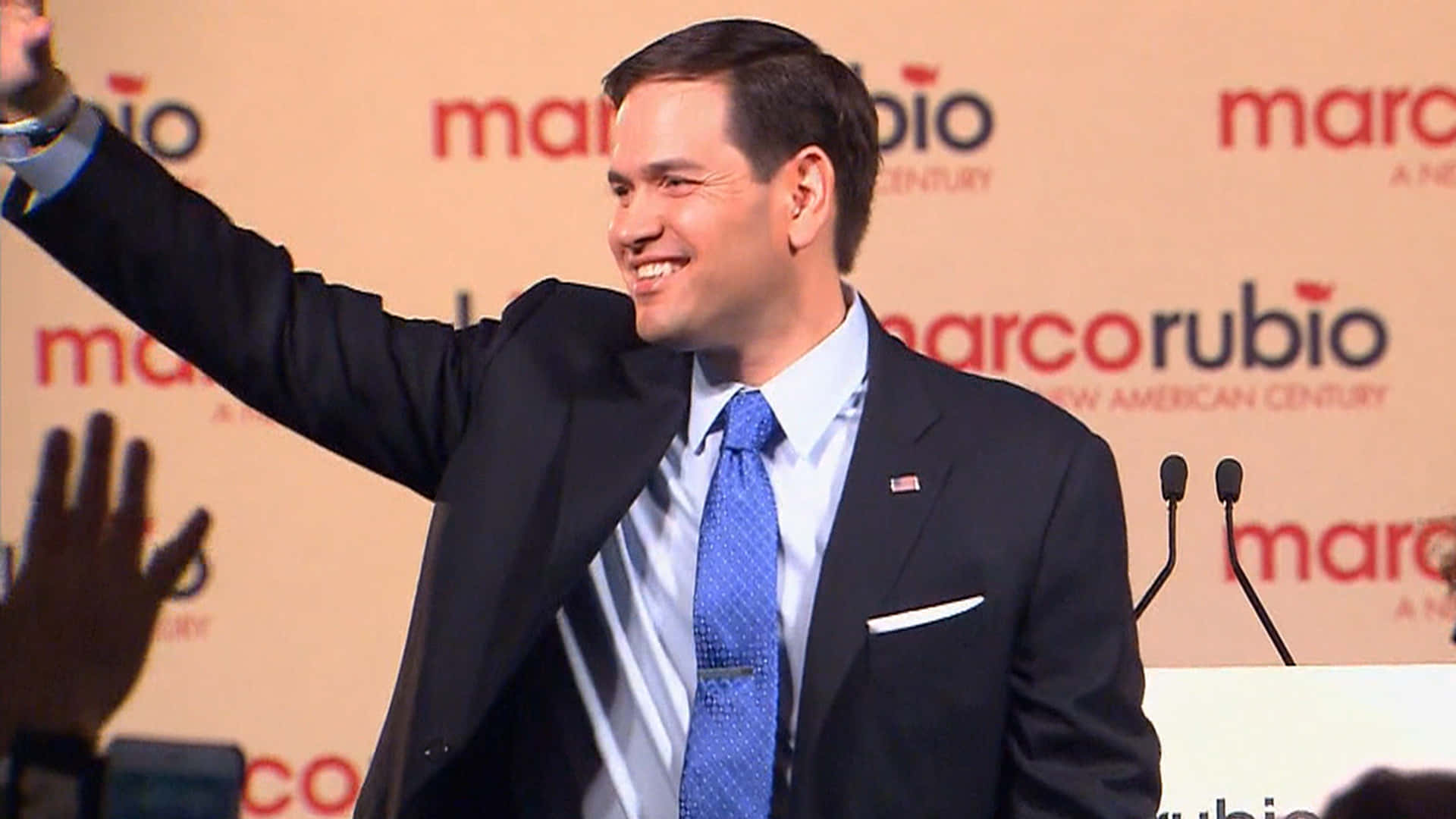 U.s Senator Marco Rubio Waving At Crowd Background