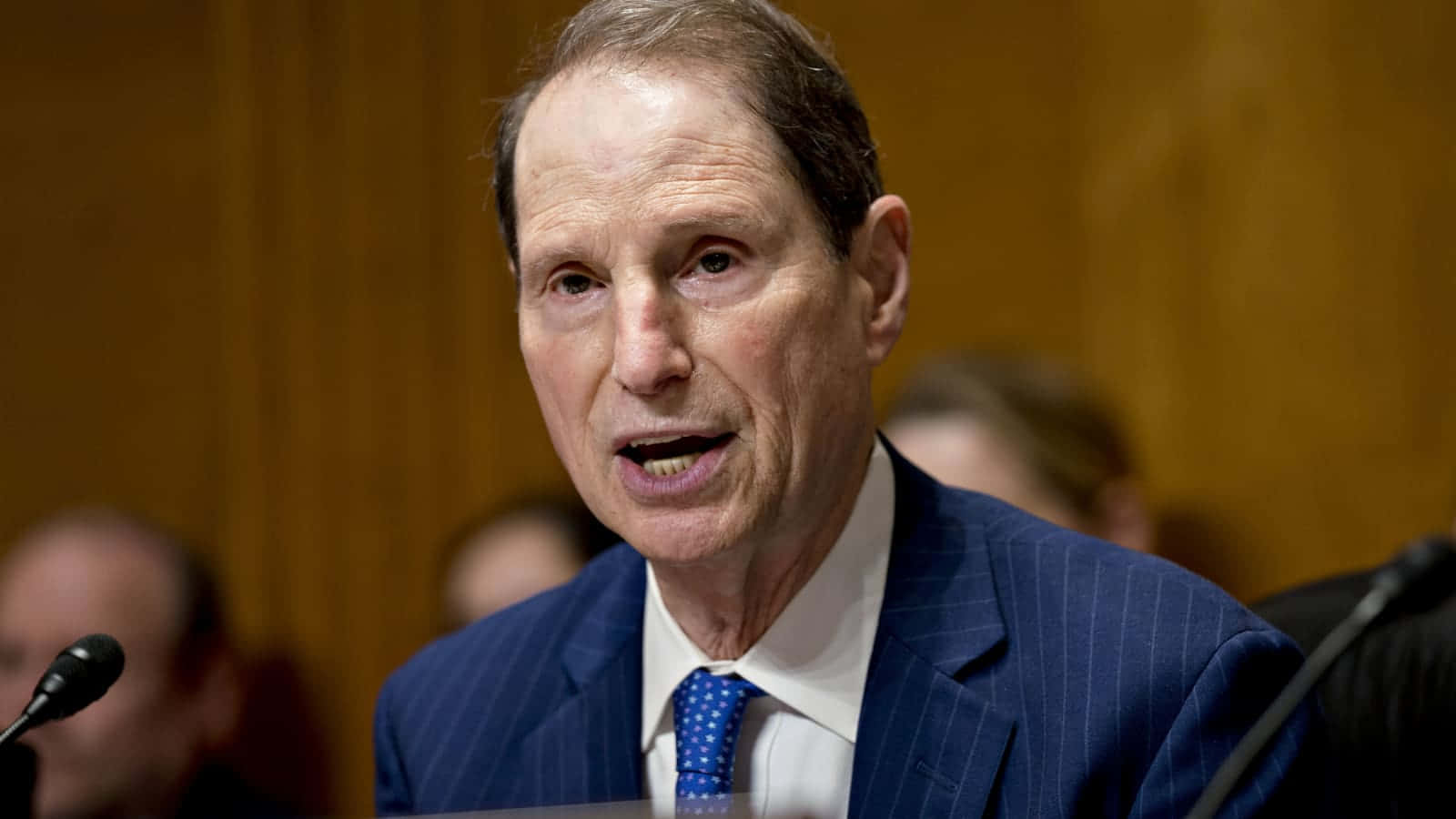 U.s. Senator Ron Wyden Looking Thoughtful In A Blue Suit And Tie. Background