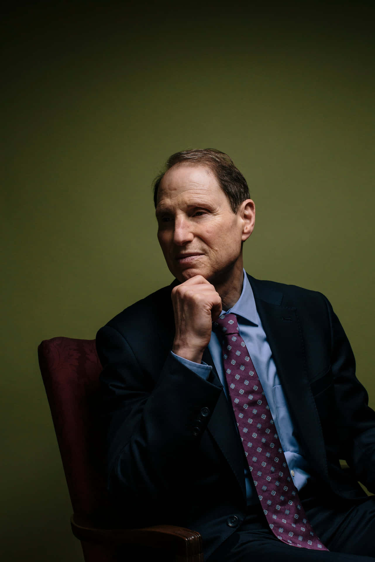 U.s Senator Ron Wyden Standing Against A Green Background Background