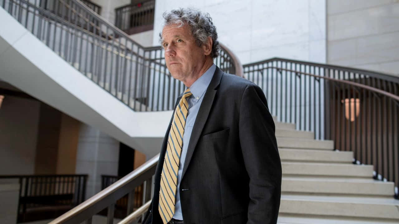 U.s. Senator Sherrod Brown Descending Stairs Background