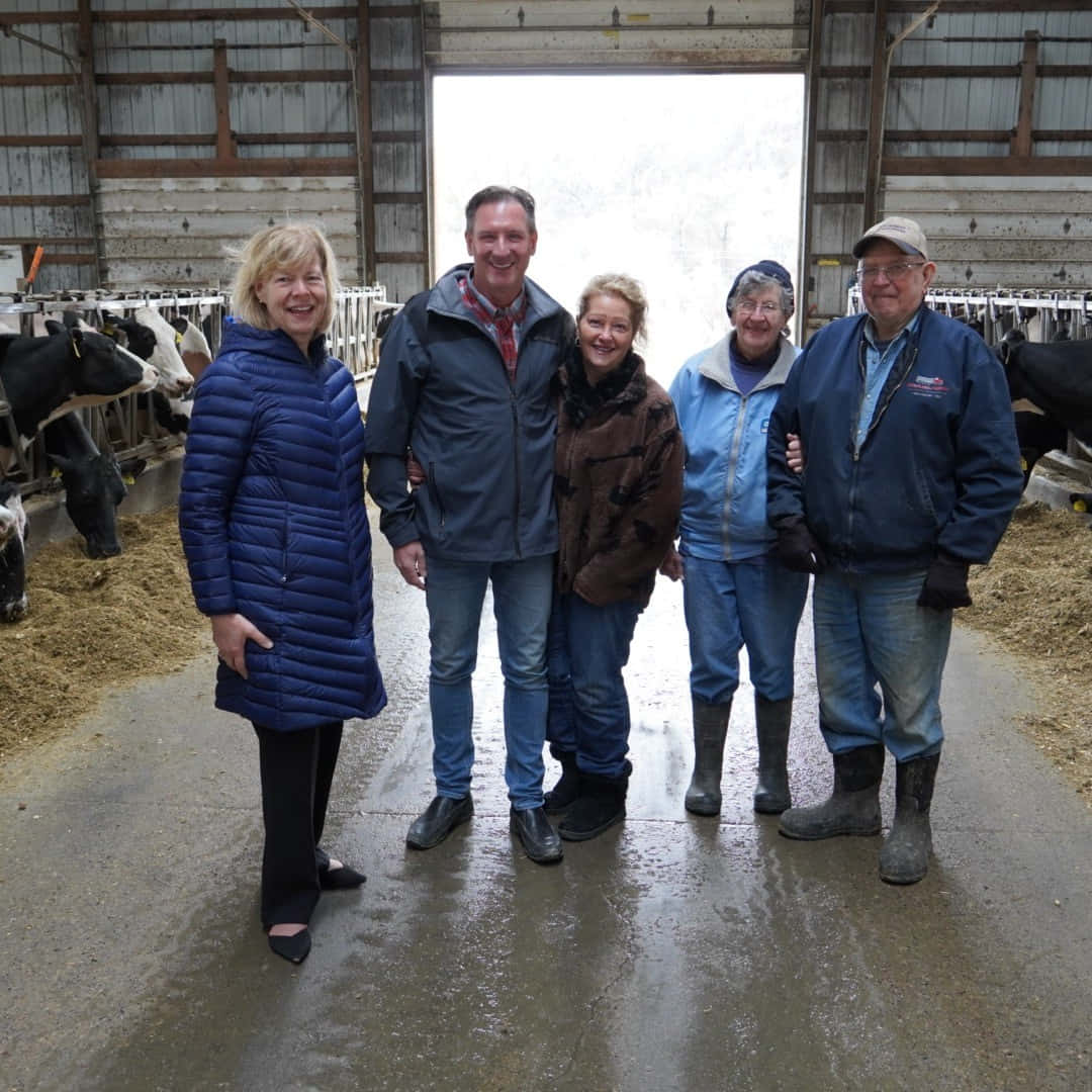 U.s Senator Tammy Baldwin On A Dairy Farm Background